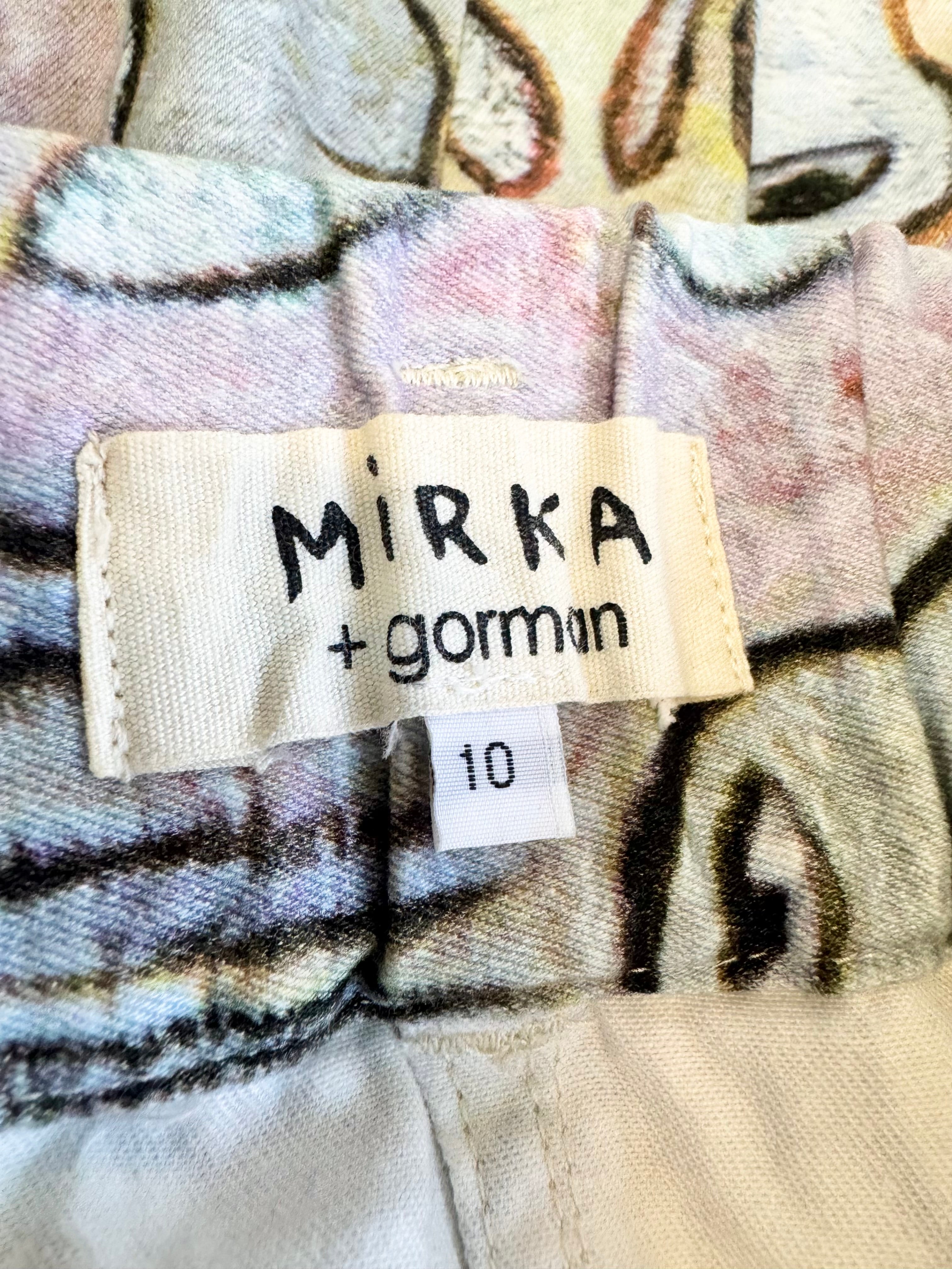Clothing label with 'Mirka + gormin' on a patterned fabric background