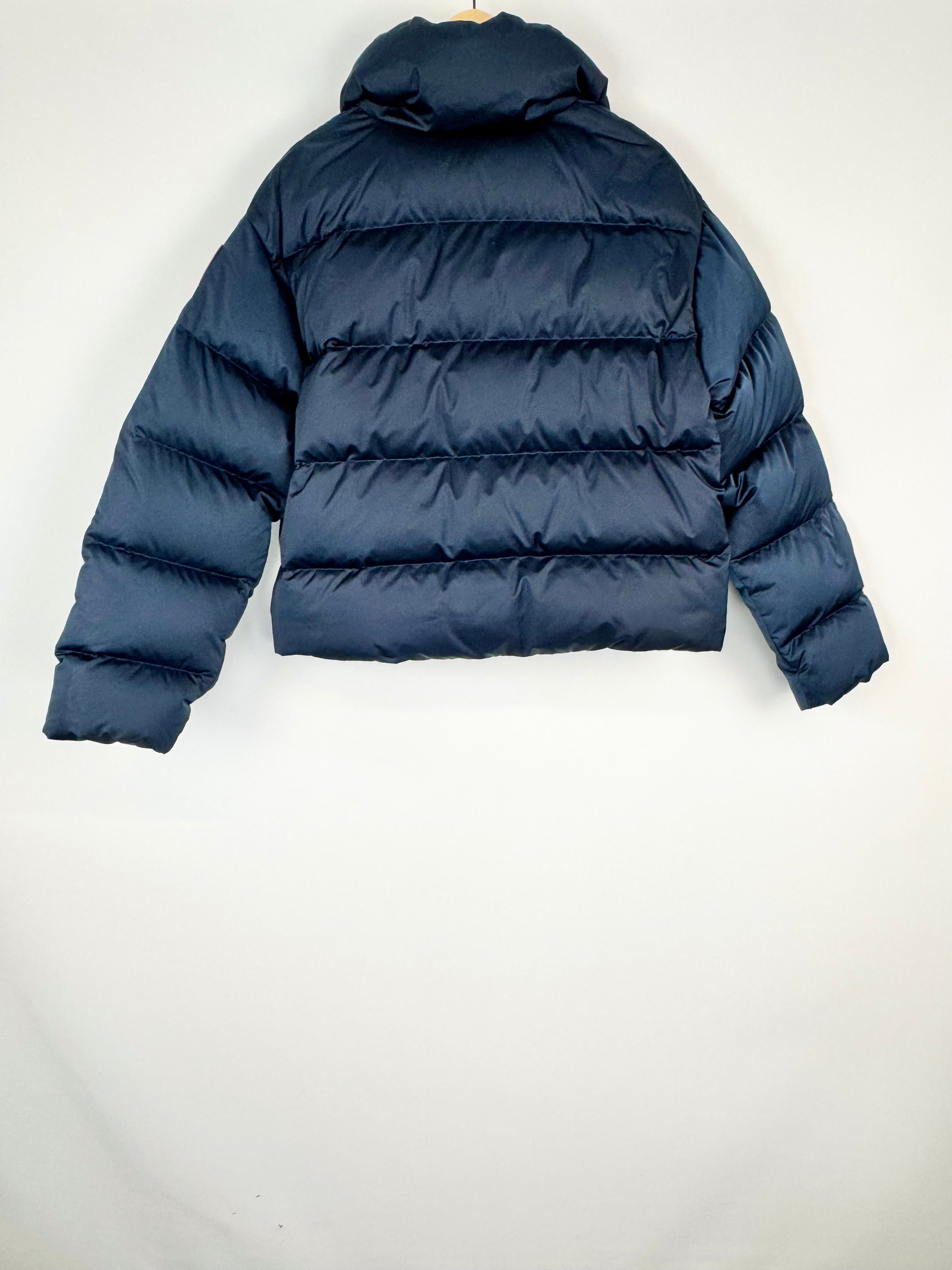 Navy blue puffer jacket on a white background
