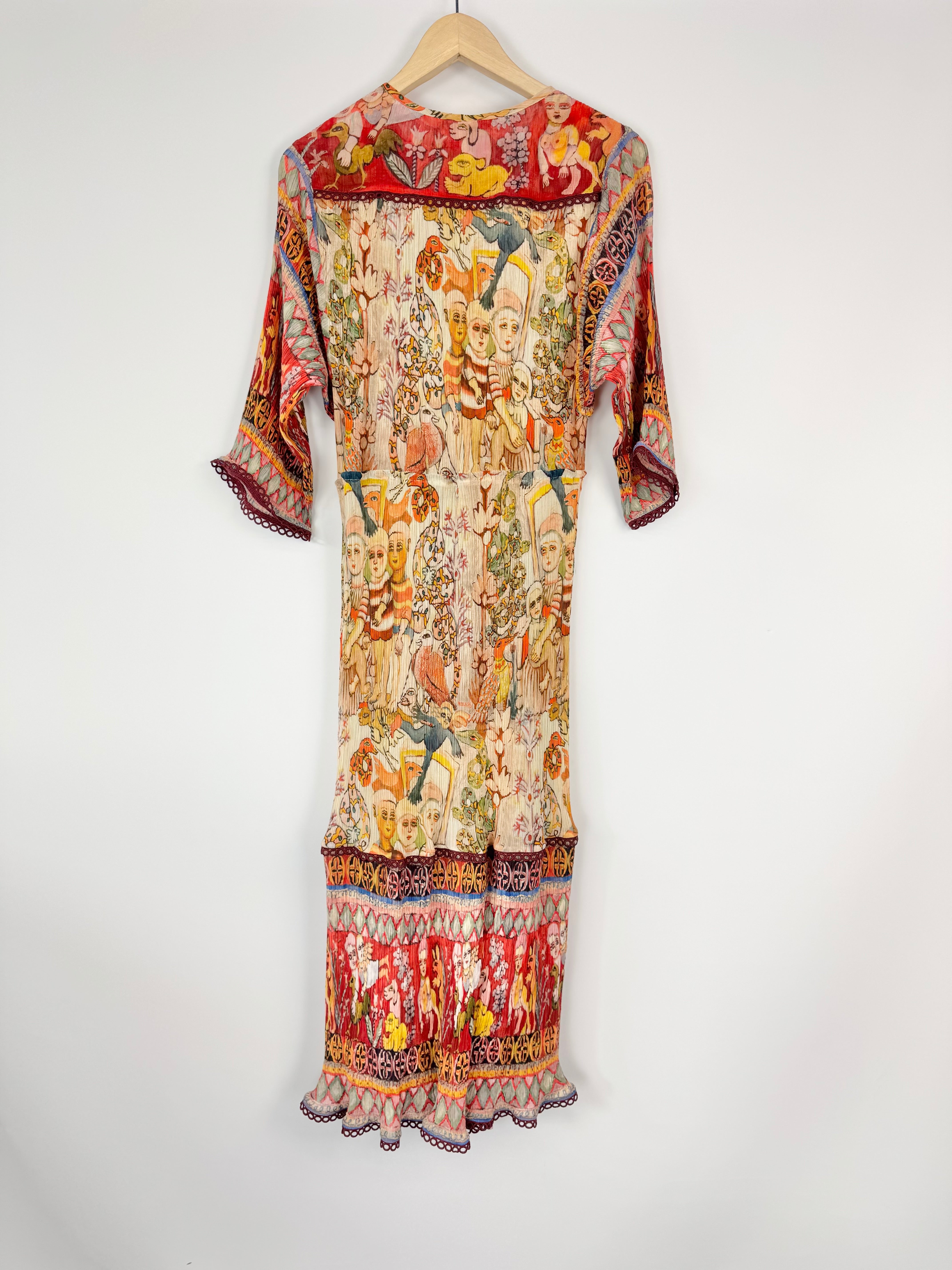 Colorful patterned dress on a hanger against a white background