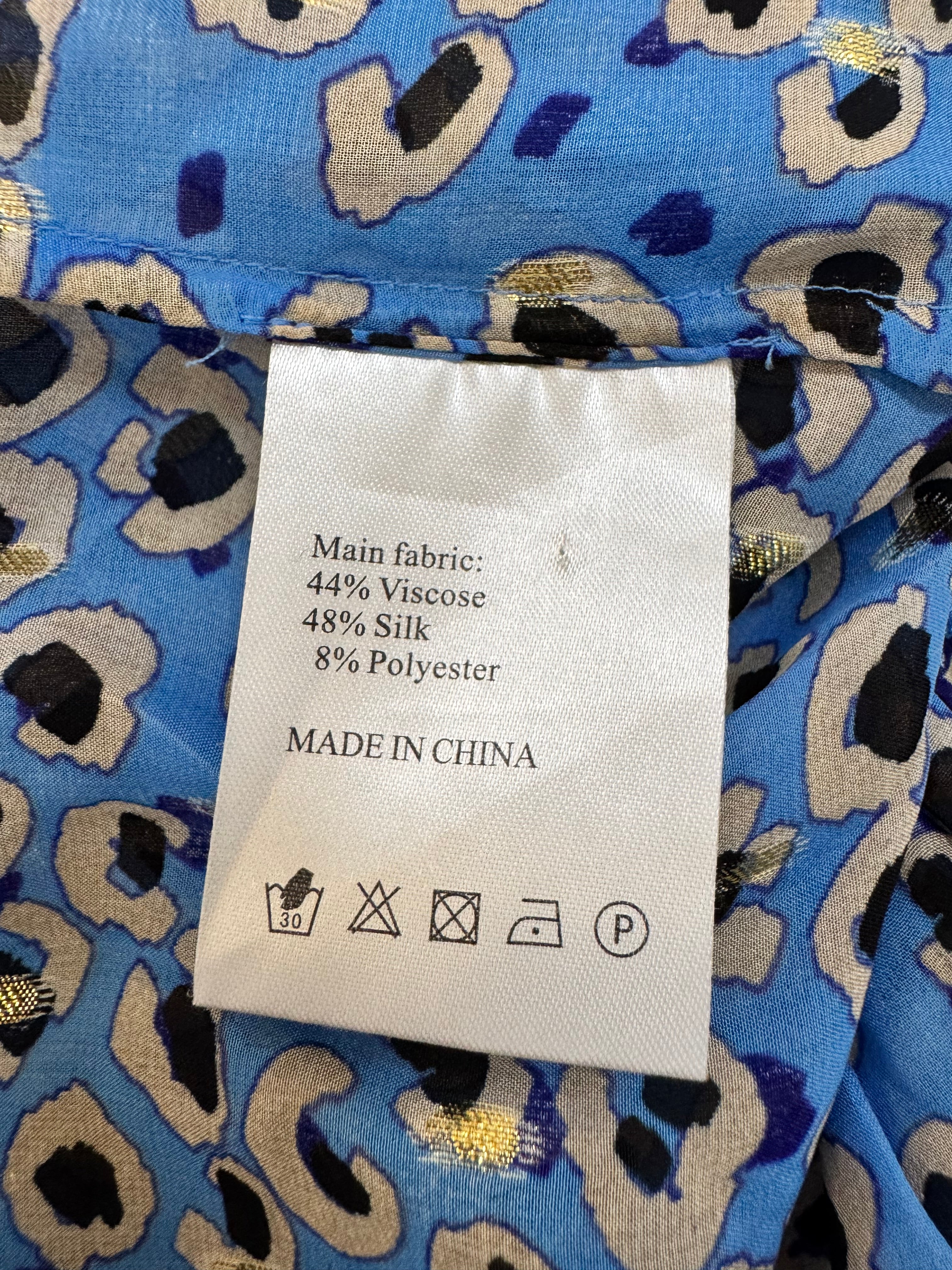Fabric with a pattern and a label showing fabric composition and origin.