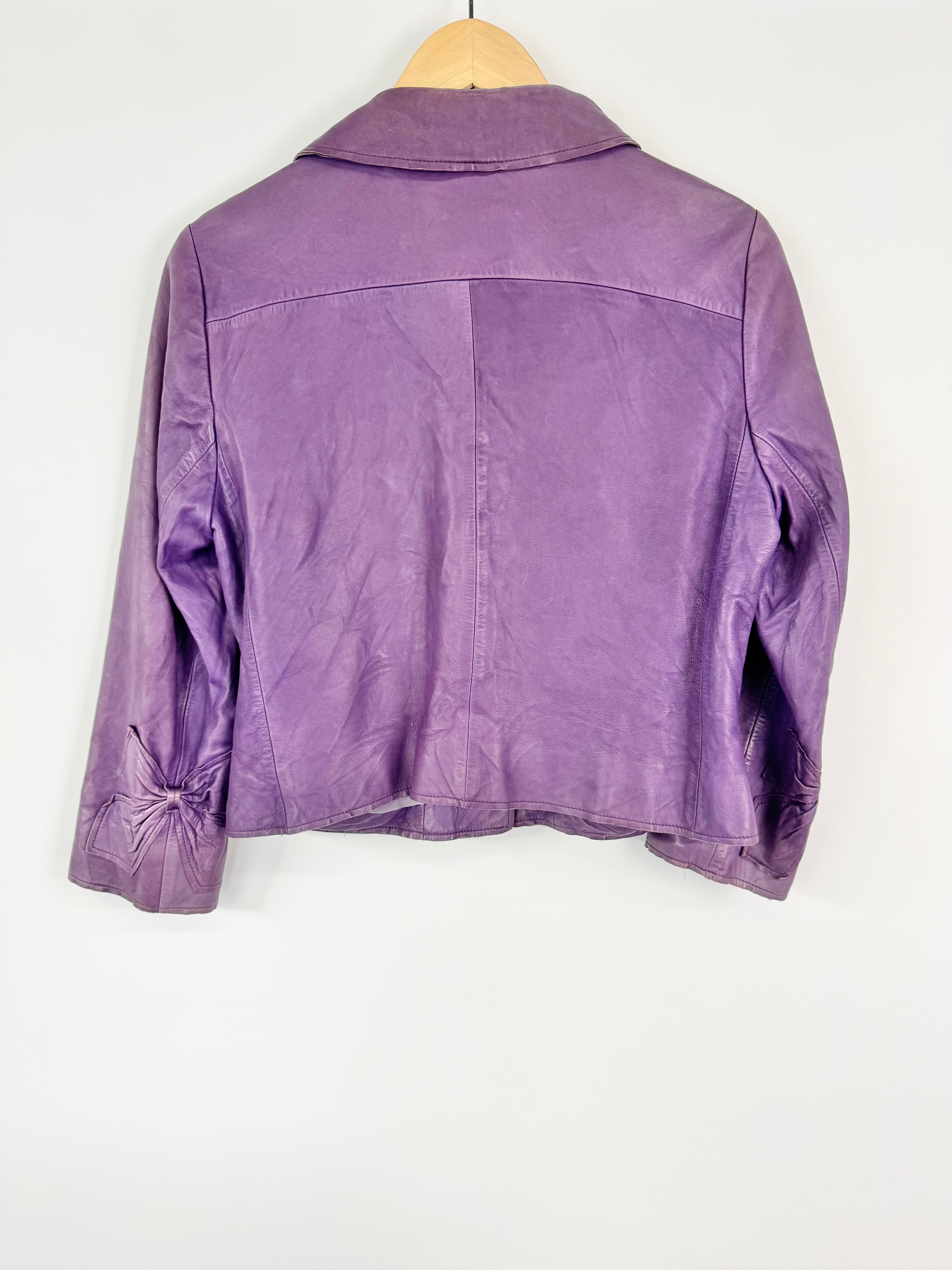 Purple jacket on a wooden hanger against a white background