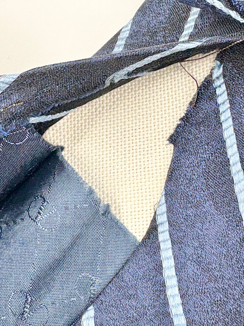 Close-up of blue denim fabric with a beige lining