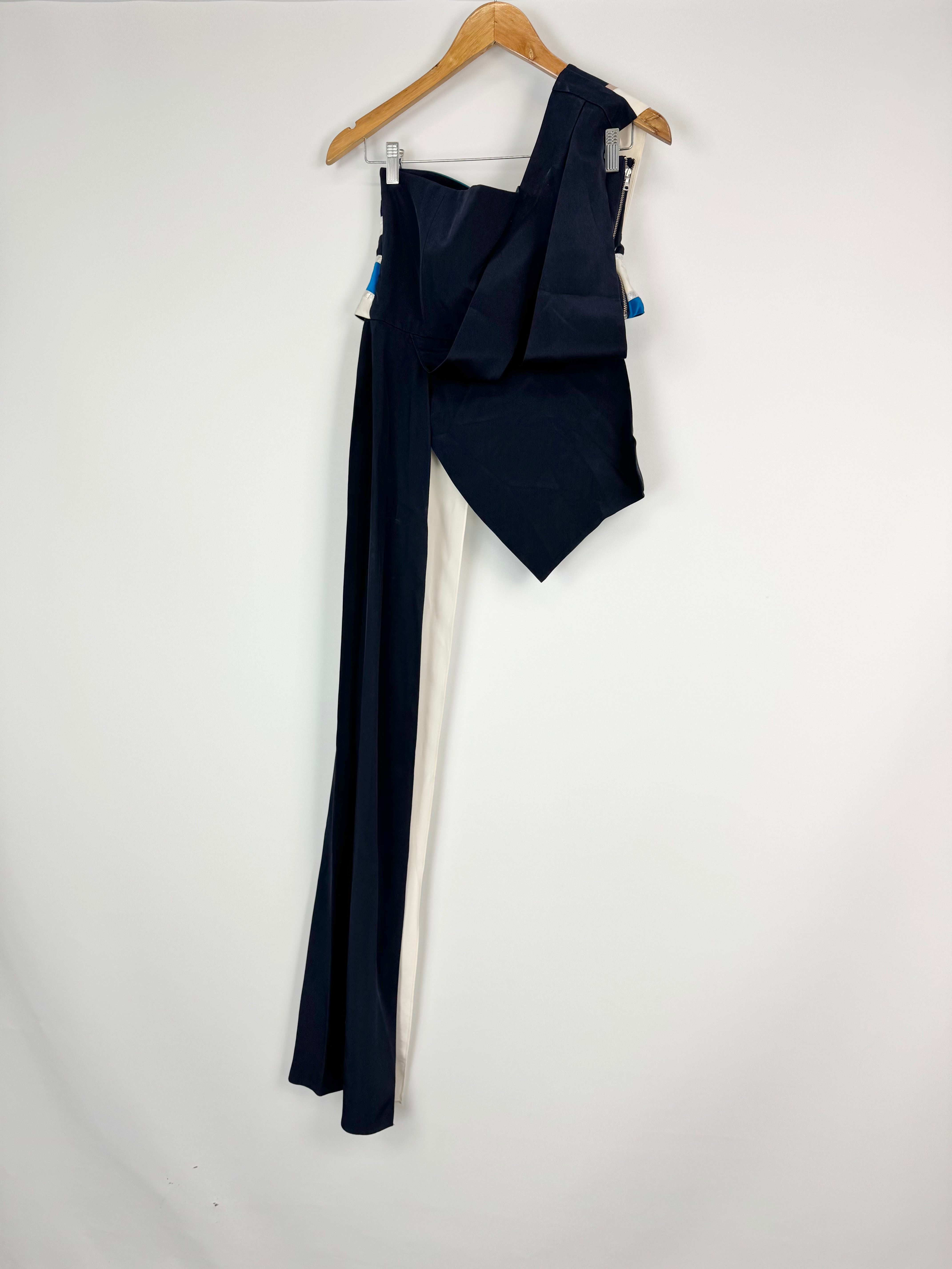 Navy blue dress on a hanger against a white background