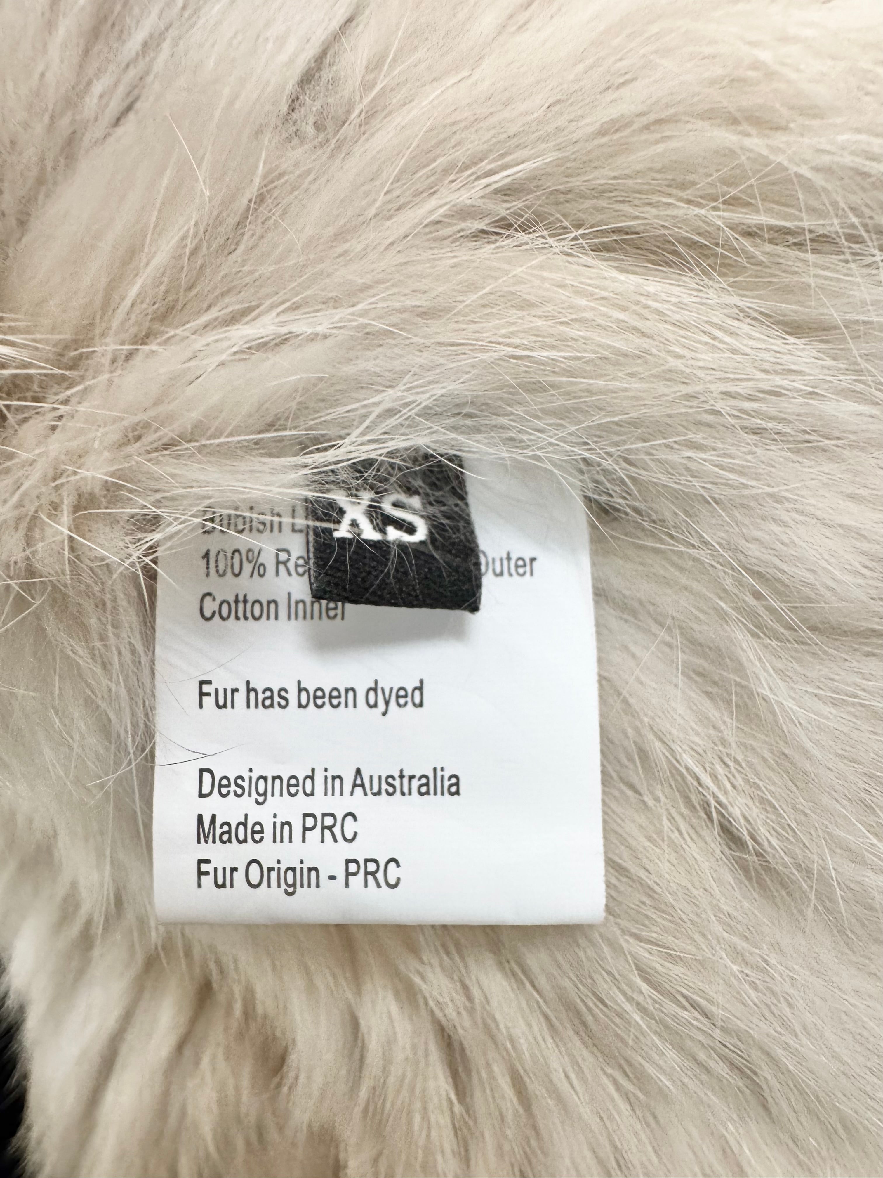 Label on fur with text about fur origin and manufacturing details