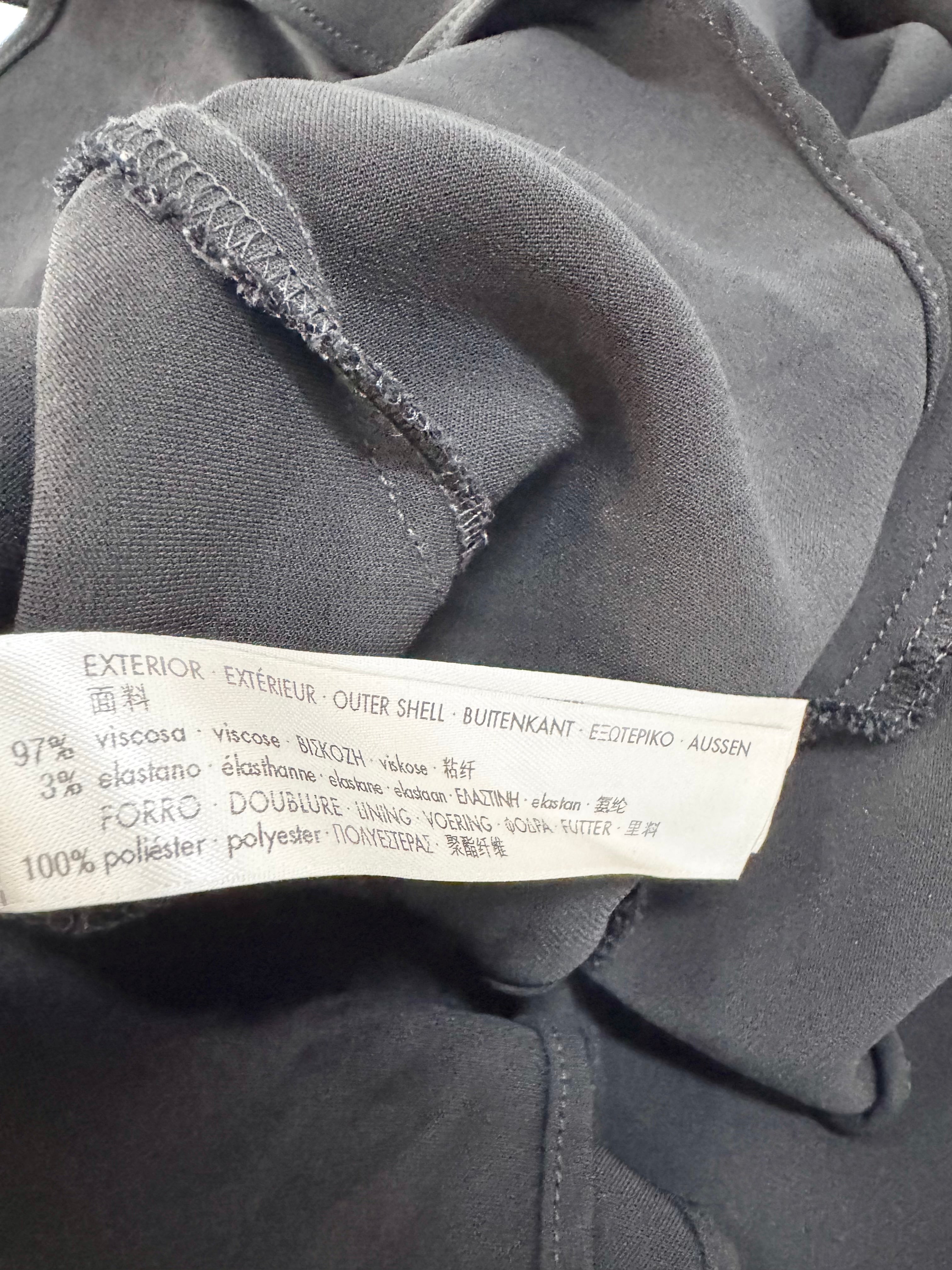Close-up of a gray fabric with a label on a dark background