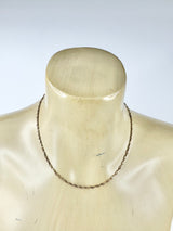 Necklace on a mannequin with a plain background