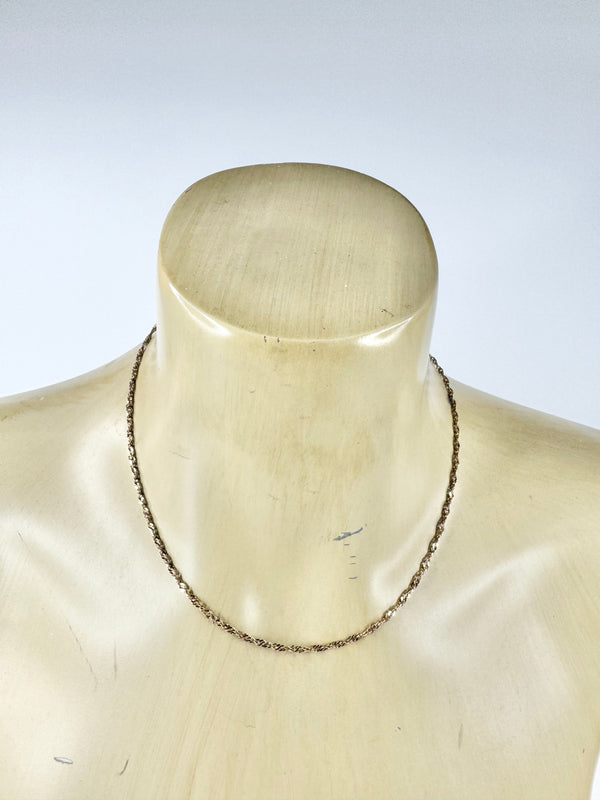 Necklace on a mannequin with a plain background