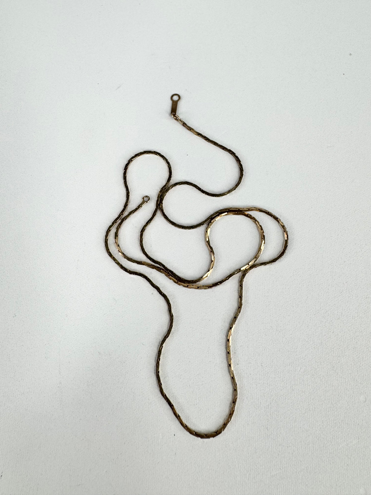 Metallic necklace on a white background