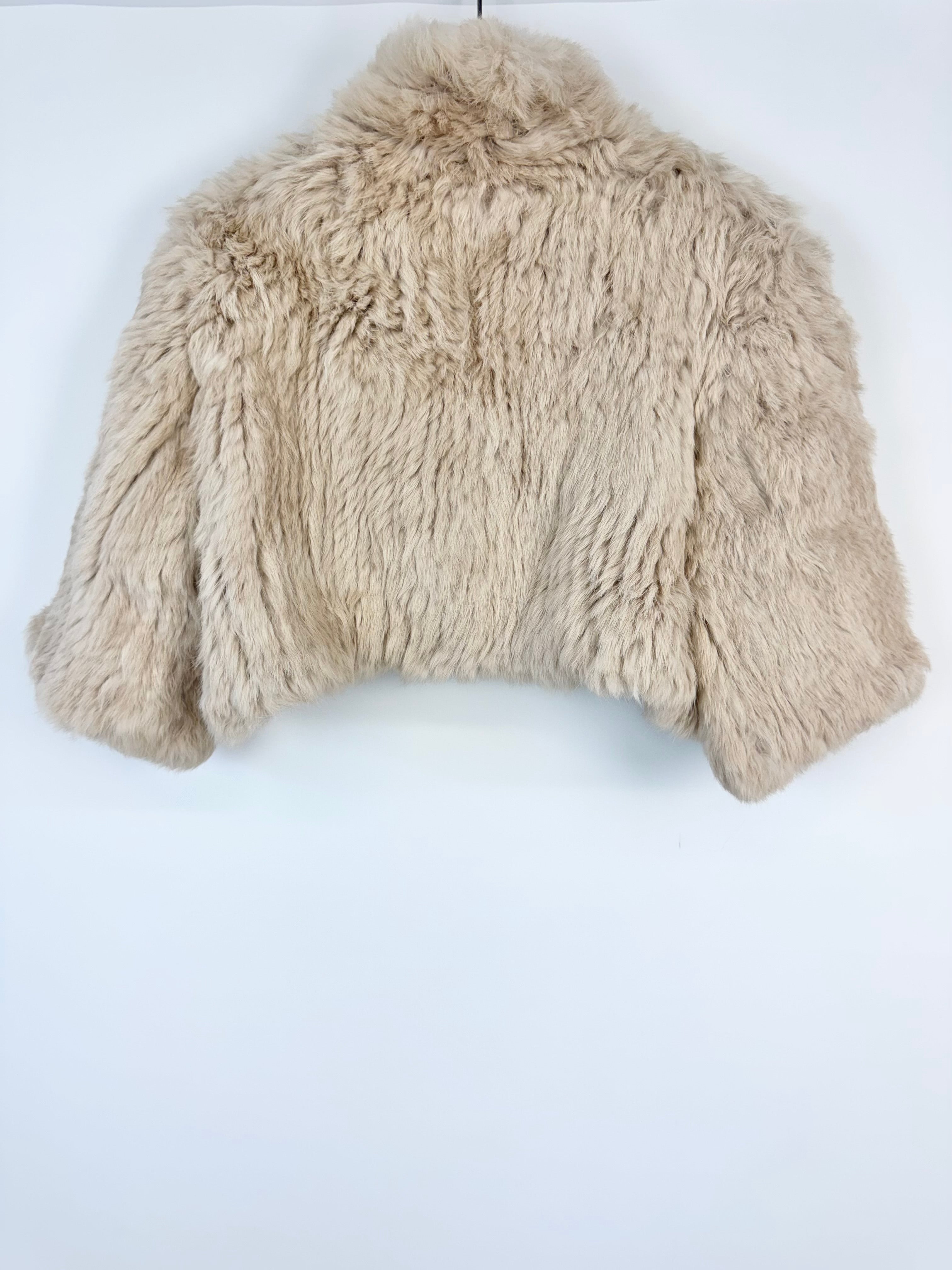 Beige faux fur jacket on a white background