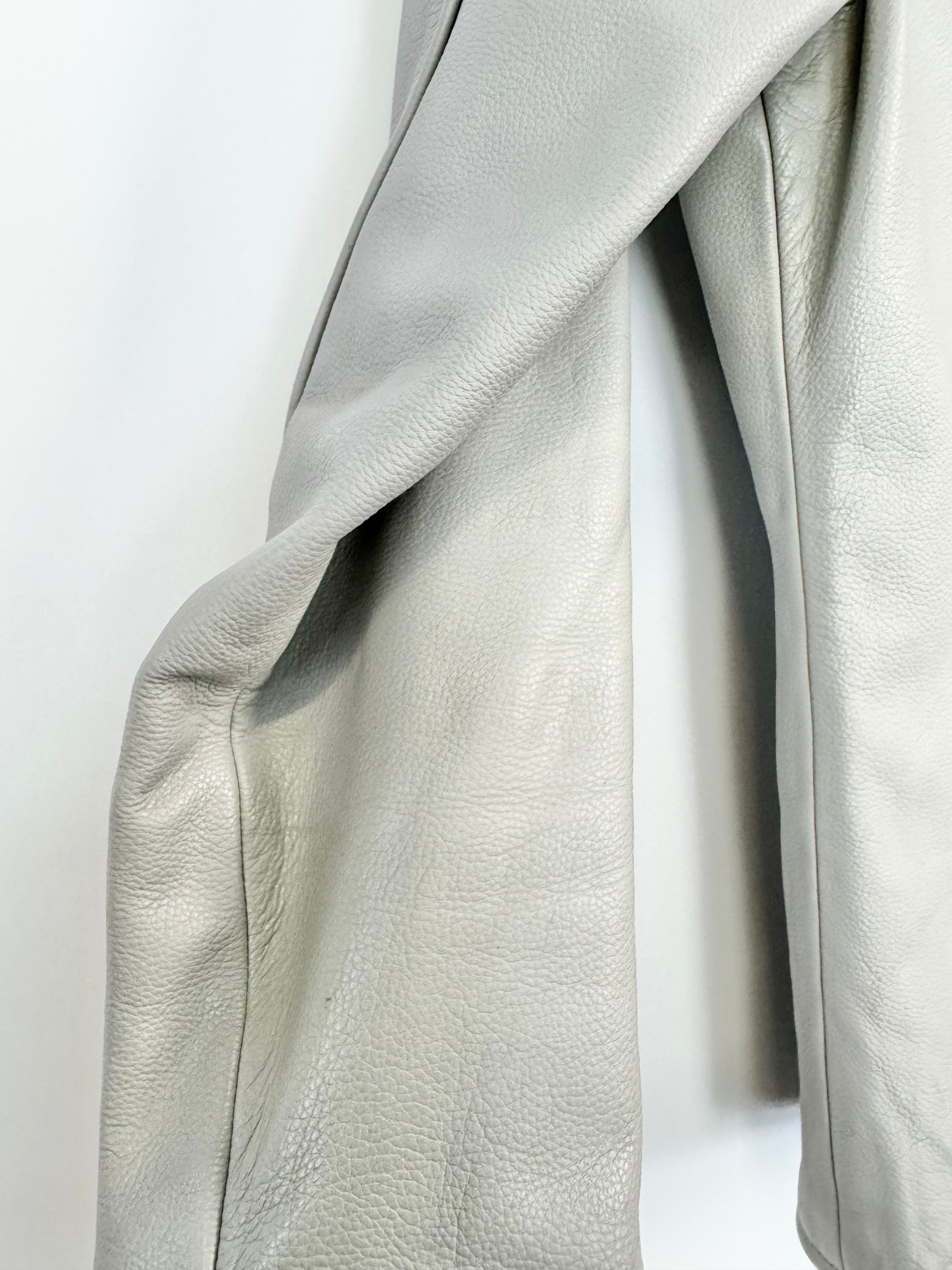 Close-up of light gray leather fabric on a white background