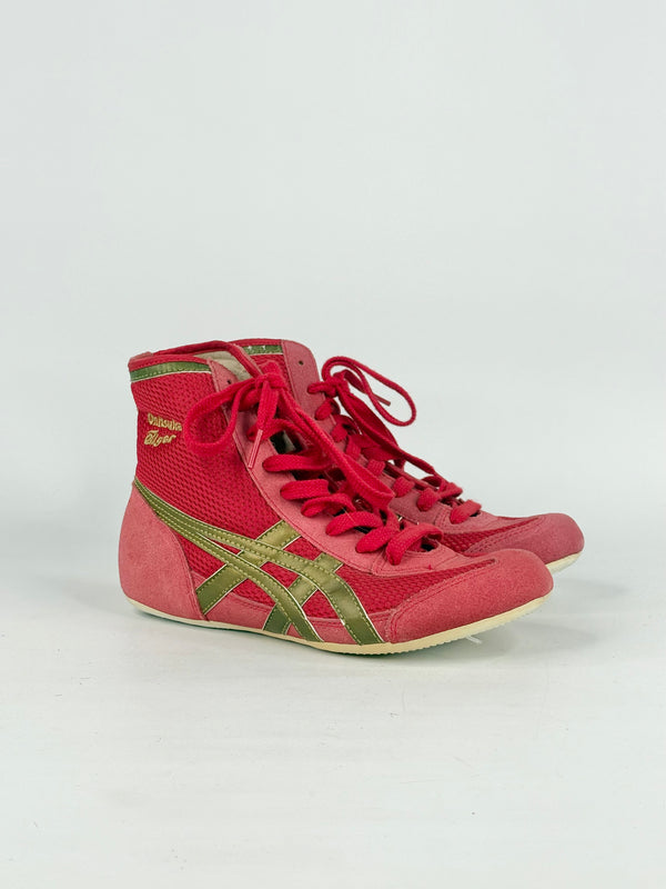 Red high-top sneakers with green accents on a white background