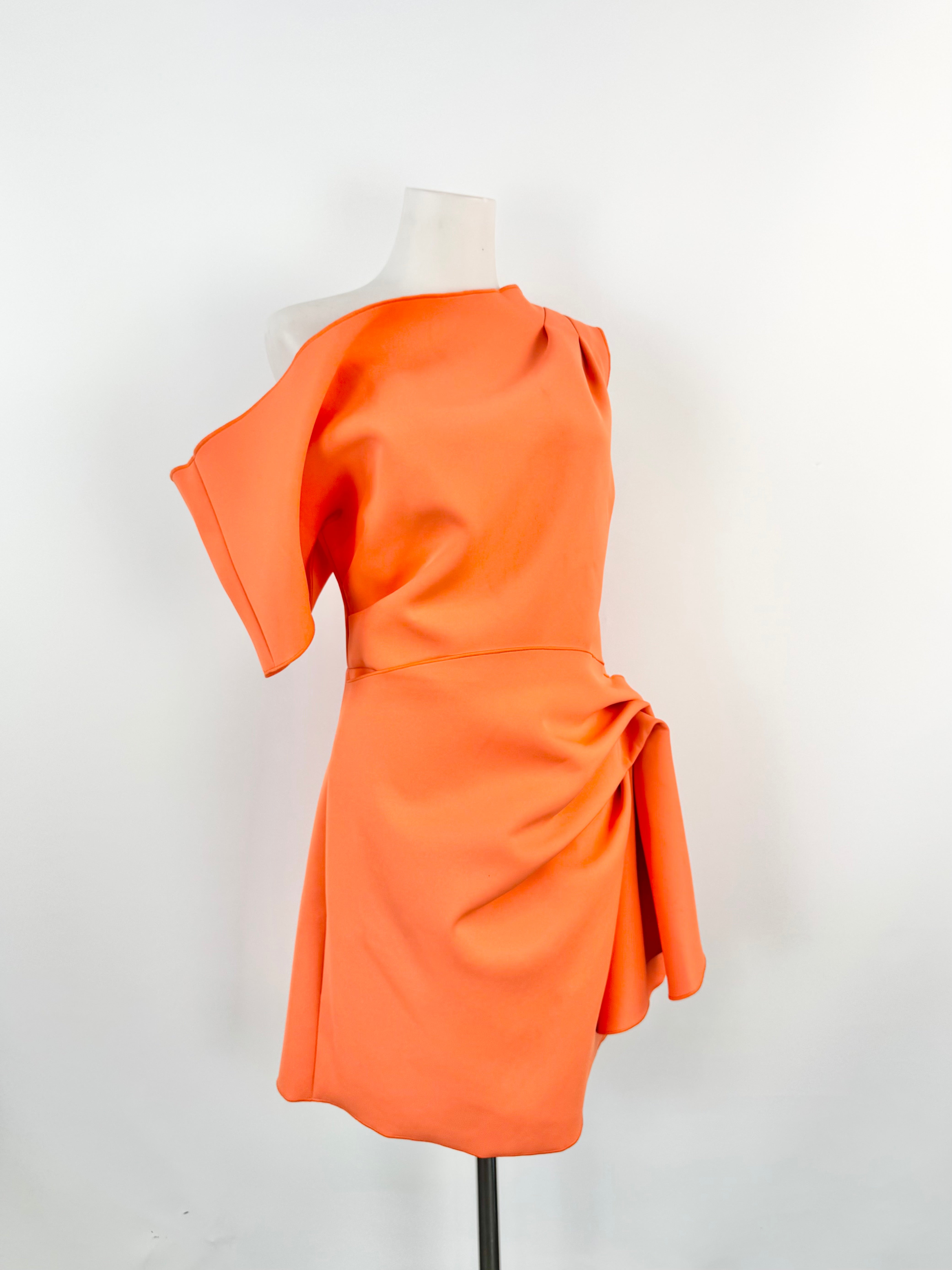 Orange dress on a mannequin against a white background