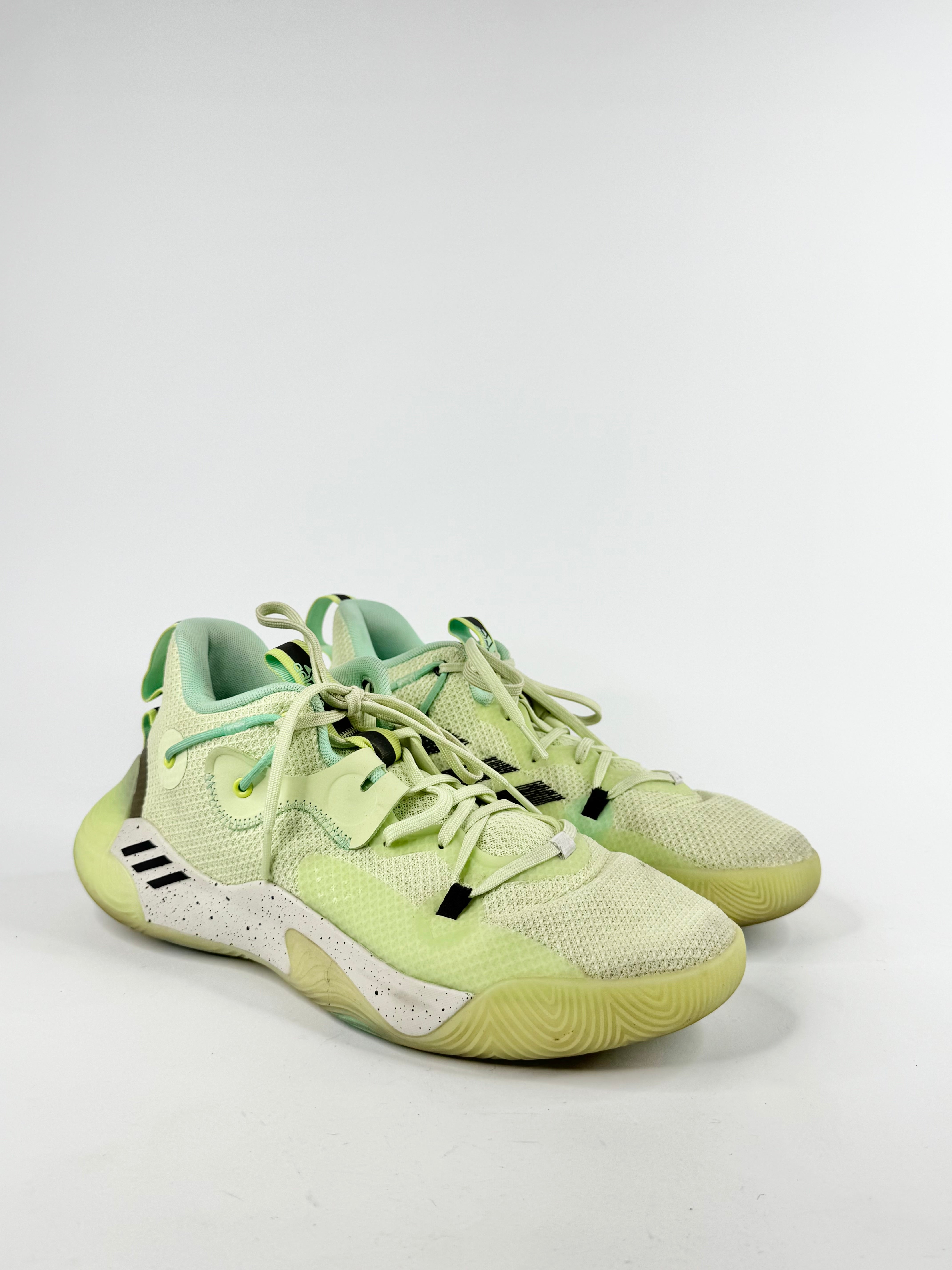 Pair of light green sneakers on a white background