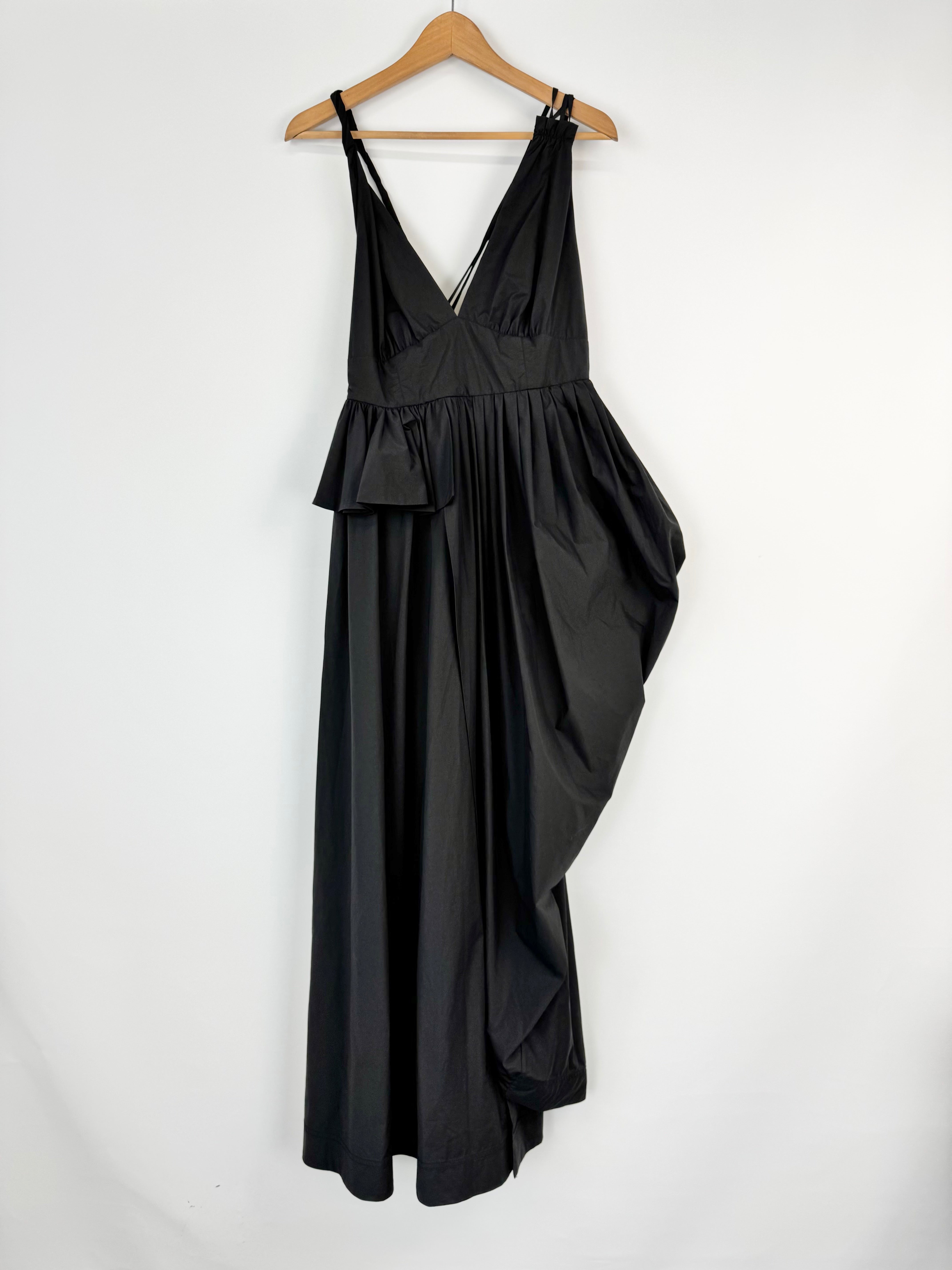 Black dress on a hanger against a white background