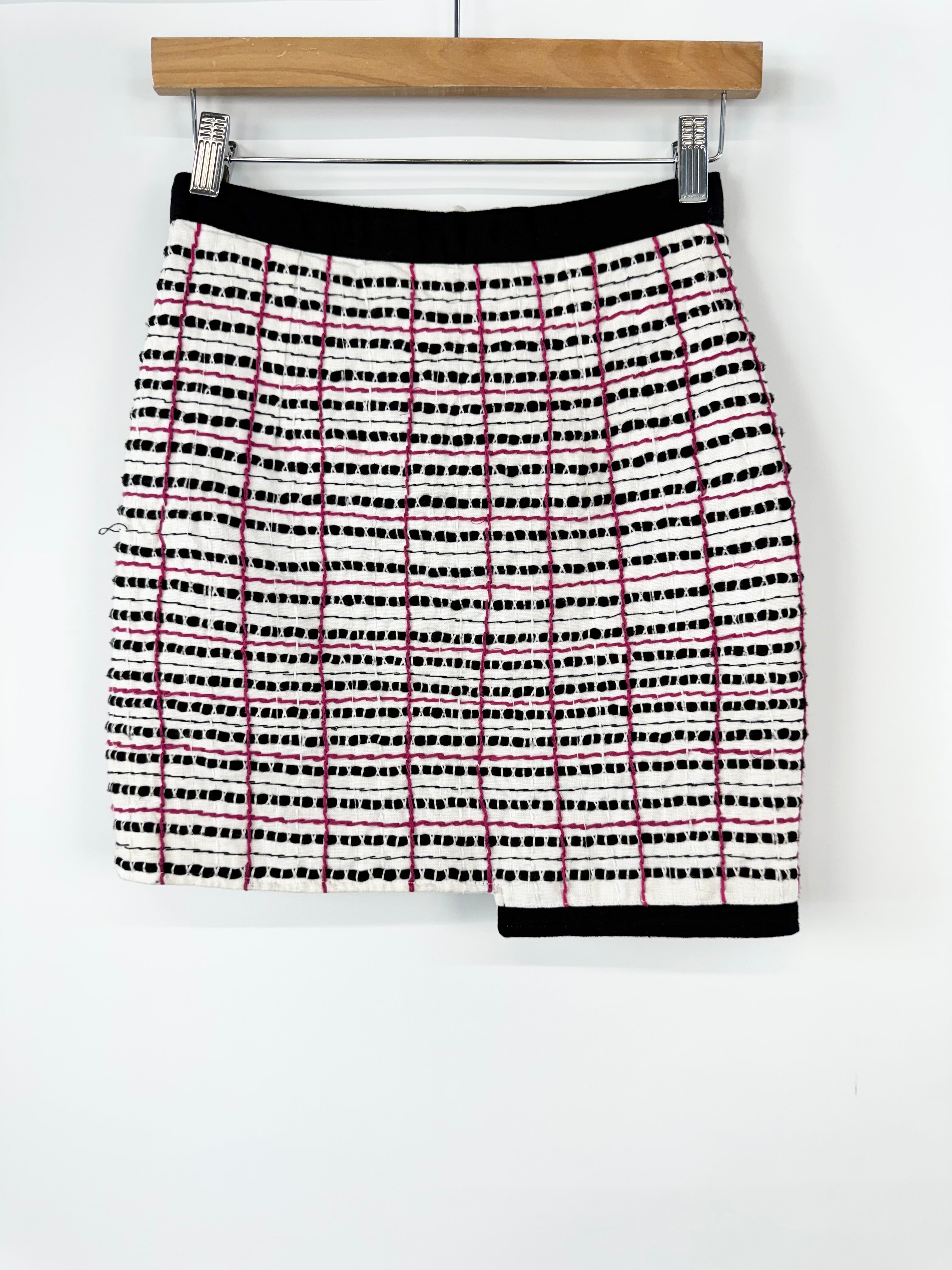 Plaid skirt with black and red pattern on a white background
