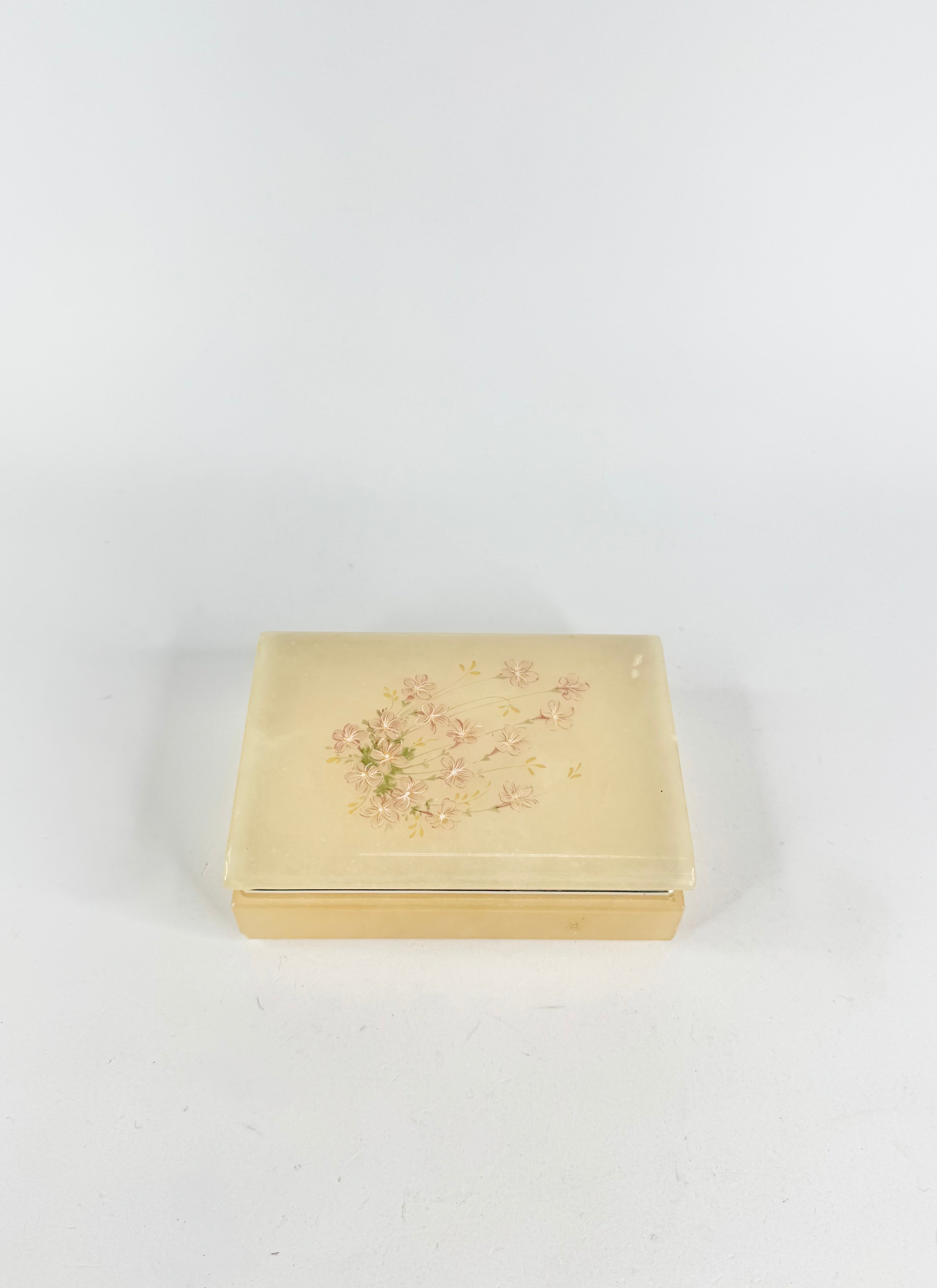 Gold jewelry box with floral design on a white background