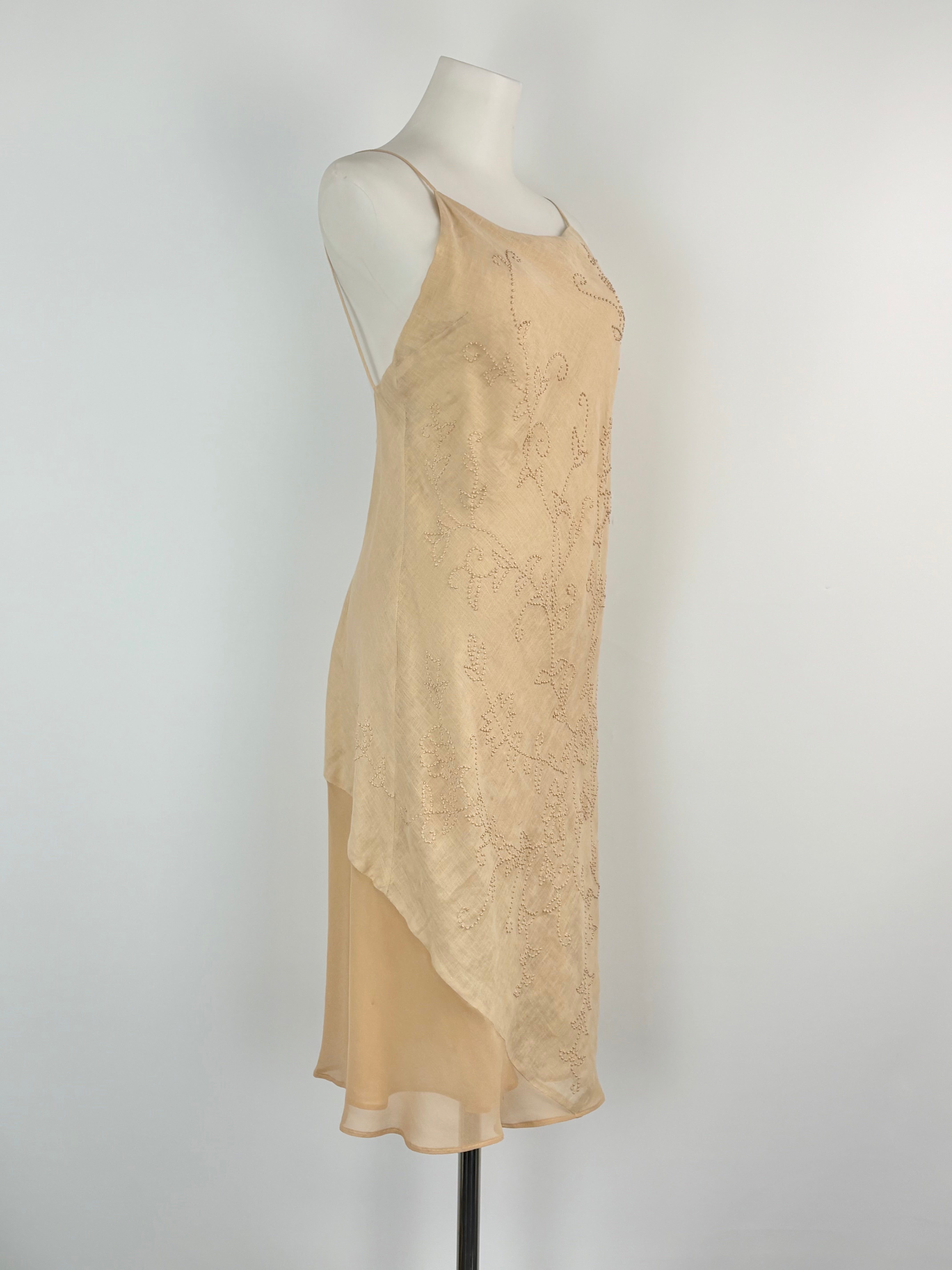 Beige slip dress on a mannequin against a white background