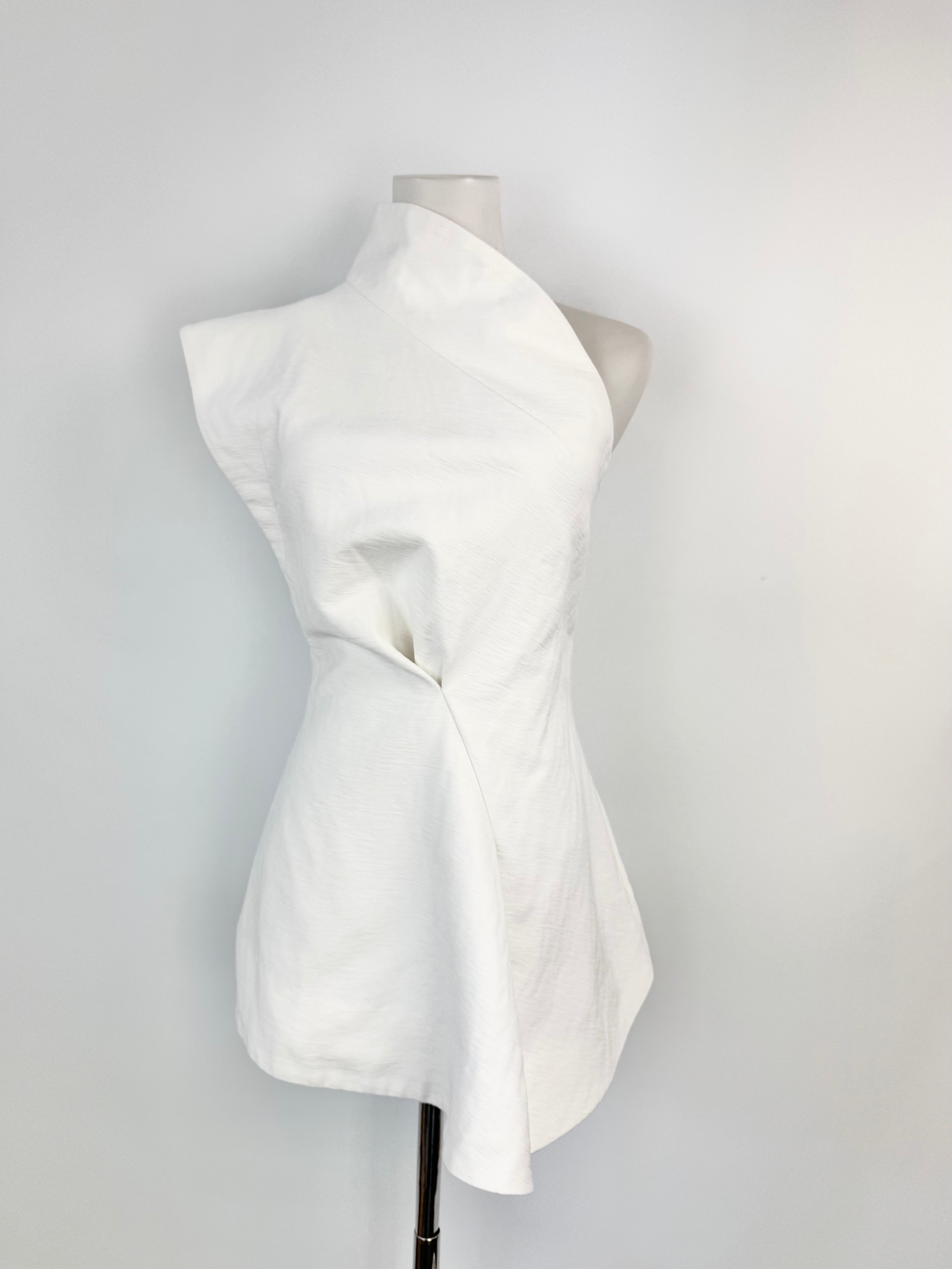 White dress on a mannequin against a plain background