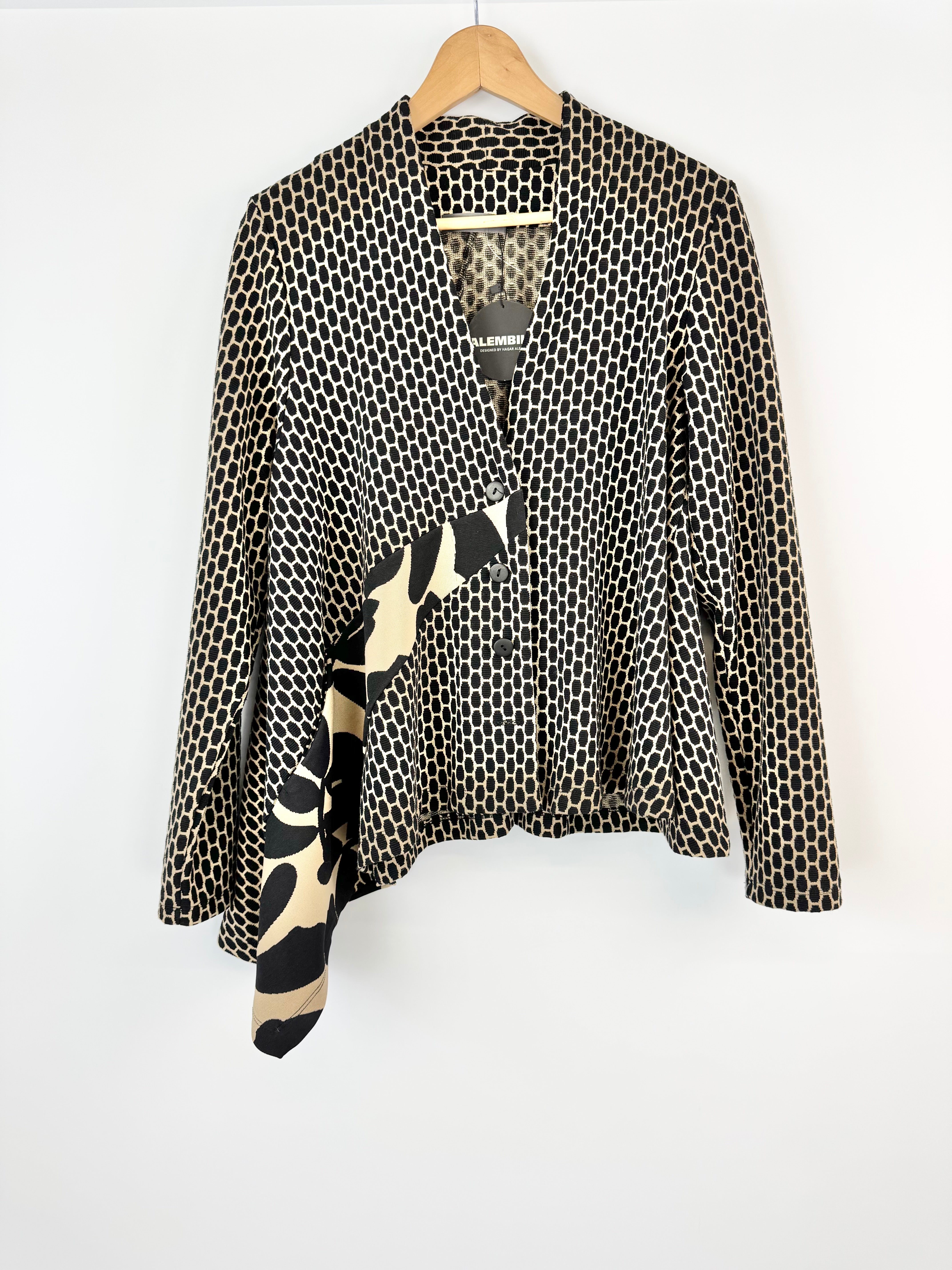 Black and white patterned jacket on a hanger with a white background