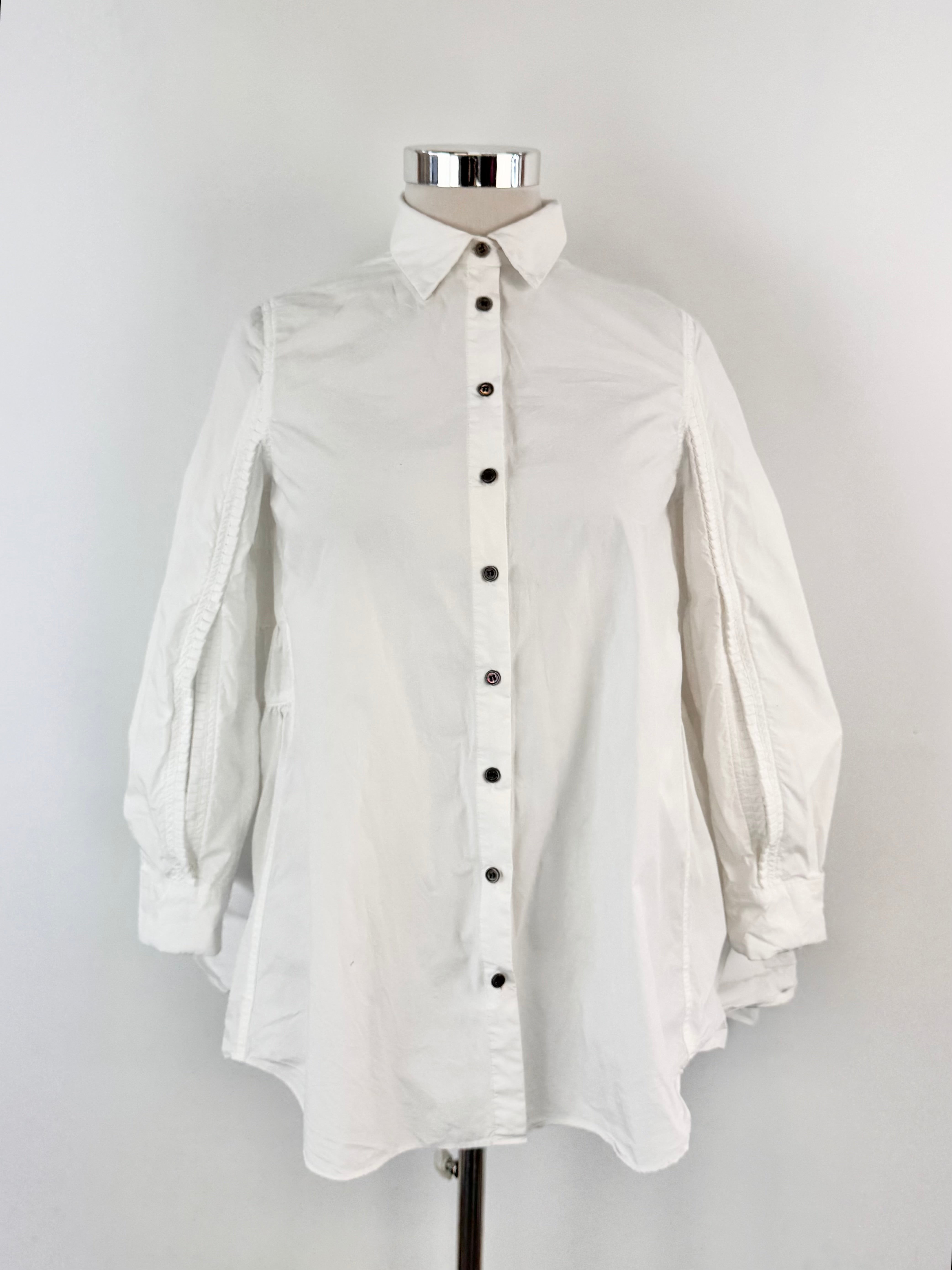 White button-up shirt on a mannequin against a plain background