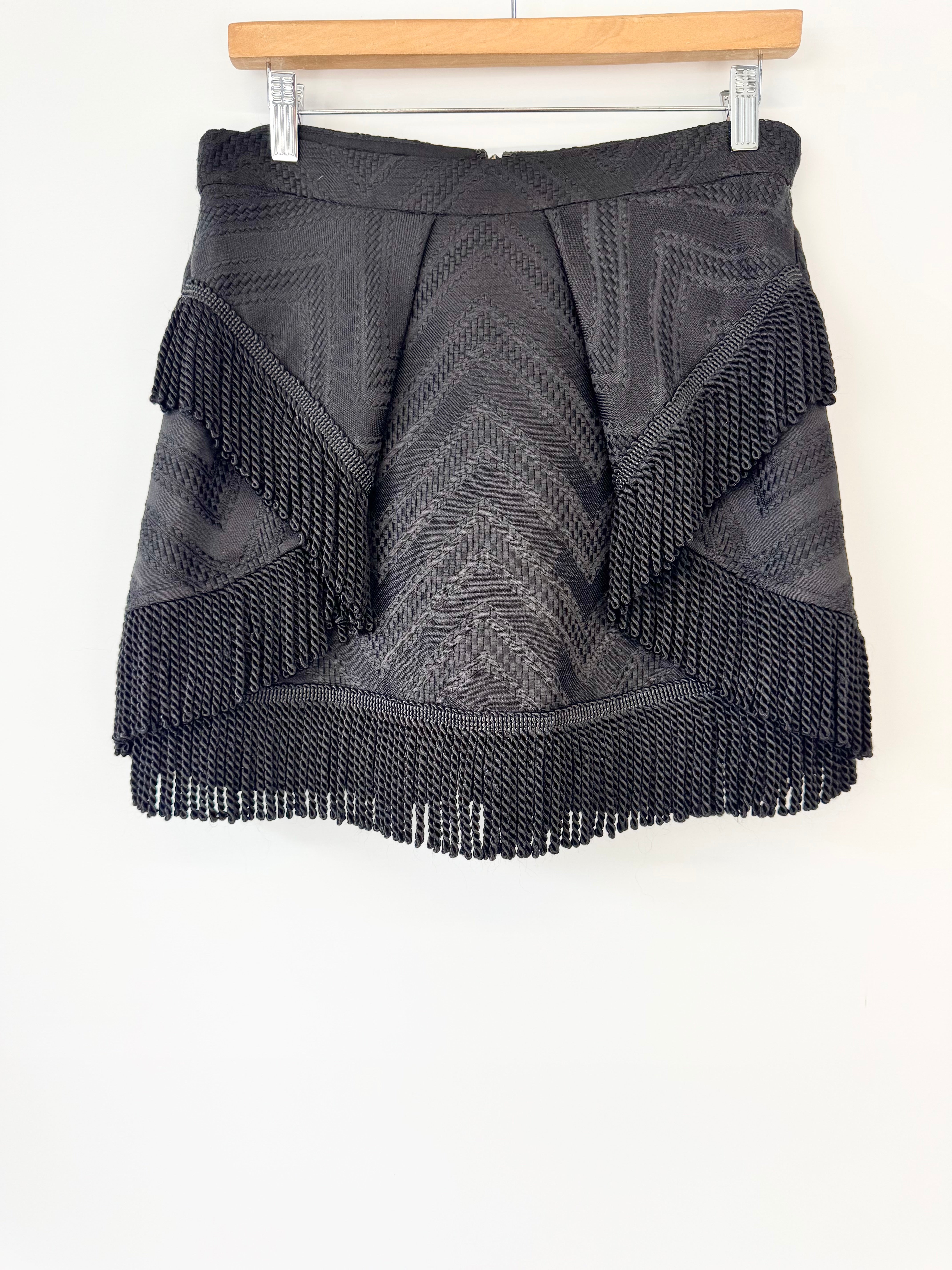 Black fringed skort on a white background