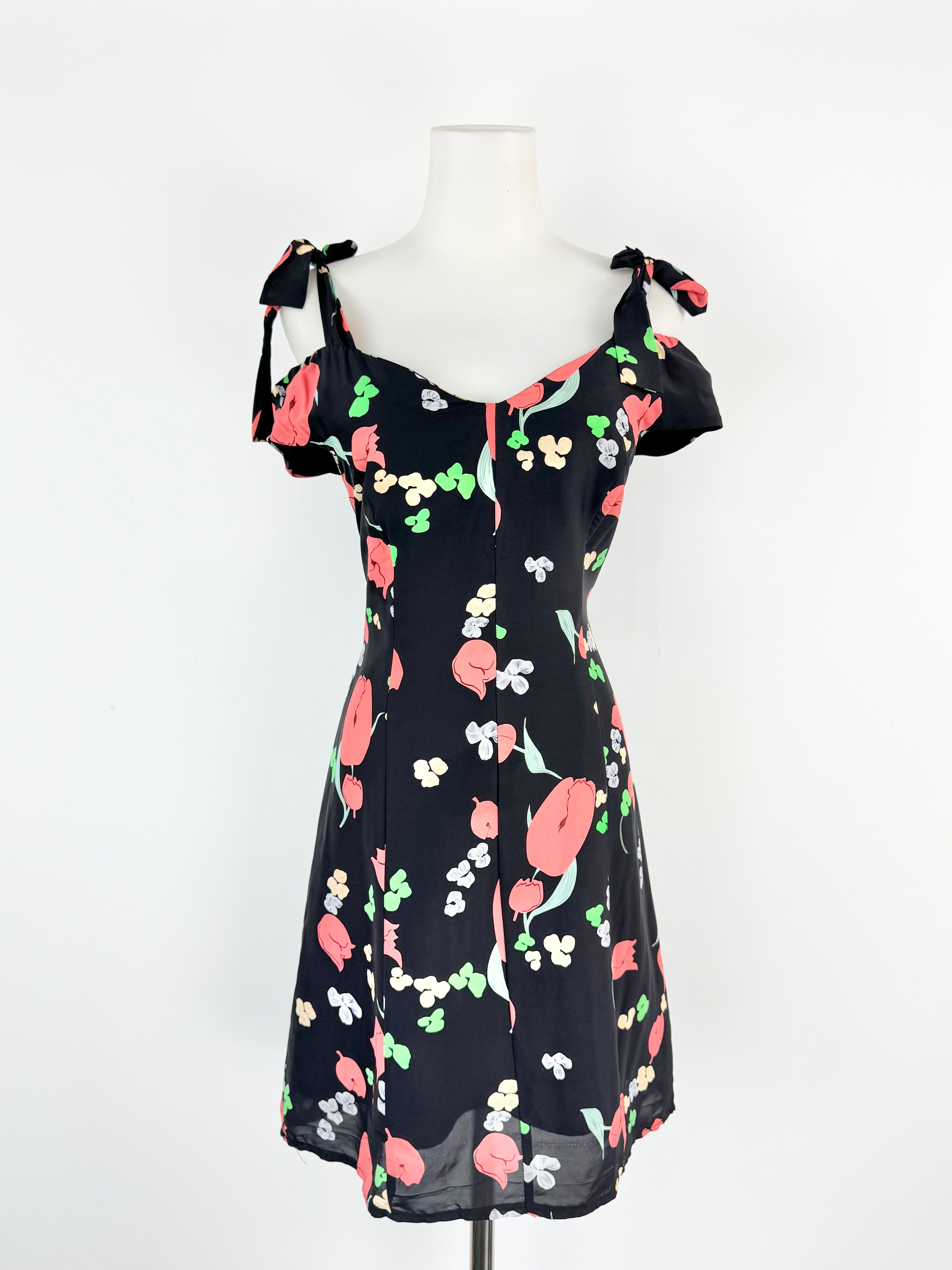 Floral dress on a mannequin against a white background