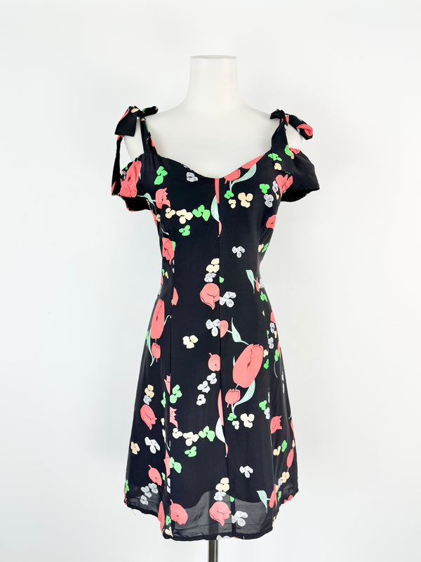 Floral dress on a mannequin against a white background