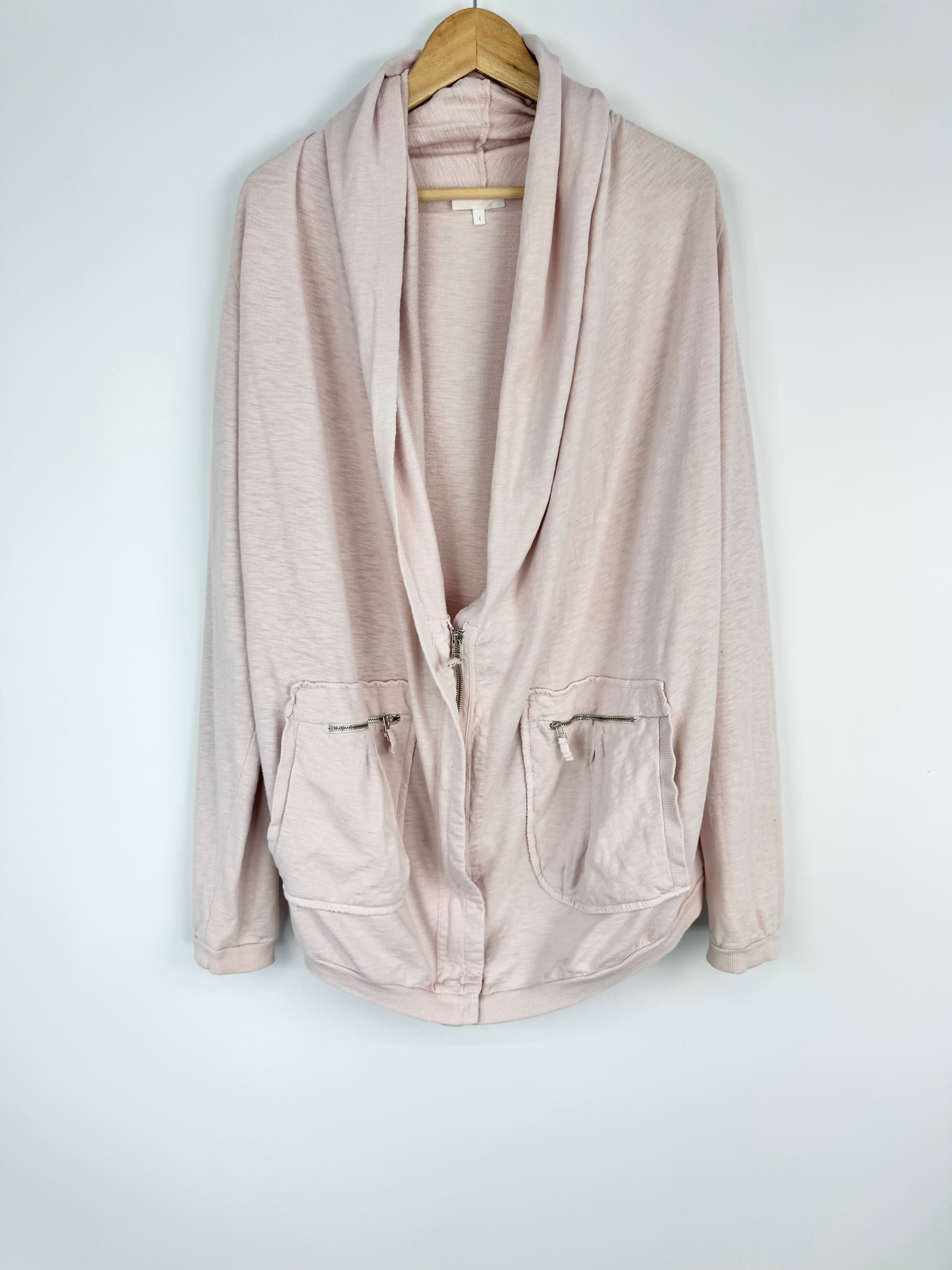 Beige jacket on a hanger against a white background