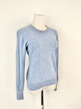Blue sweater on a mannequin against a white background