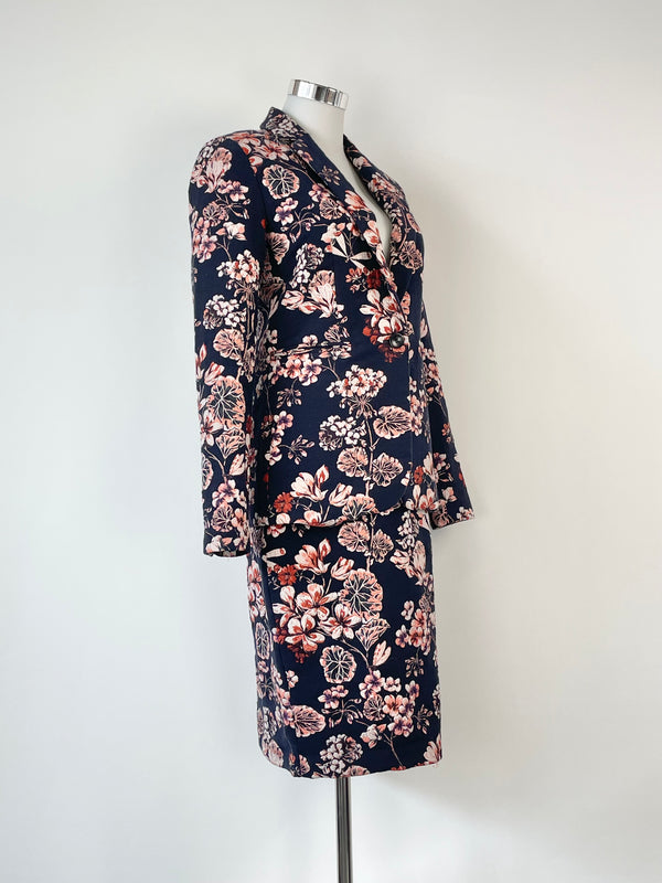 Ann Taylor navy blue floral two-piece blazer and skirt set, with the skirt displaying a floral pattern and the blazer having a solid navy color.