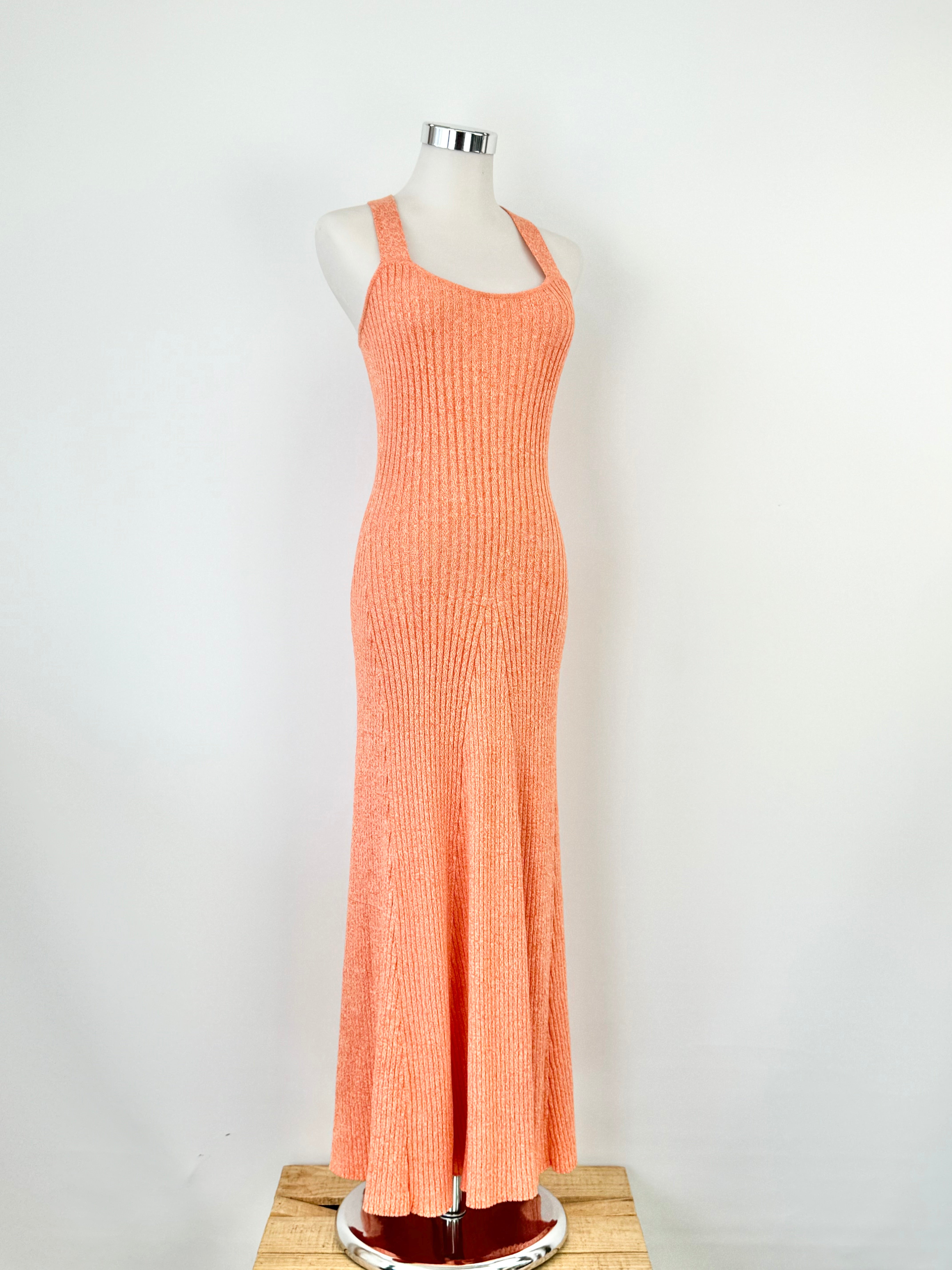 A tangerine orange ribknit maxi dress with white speckles, featuring wide straps and a flattering ribbed texture.