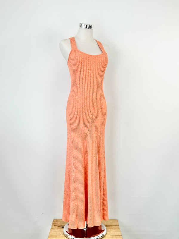 A tangerine orange ribknit maxi dress with white speckles, featuring wide straps and a flattering ribbed texture.