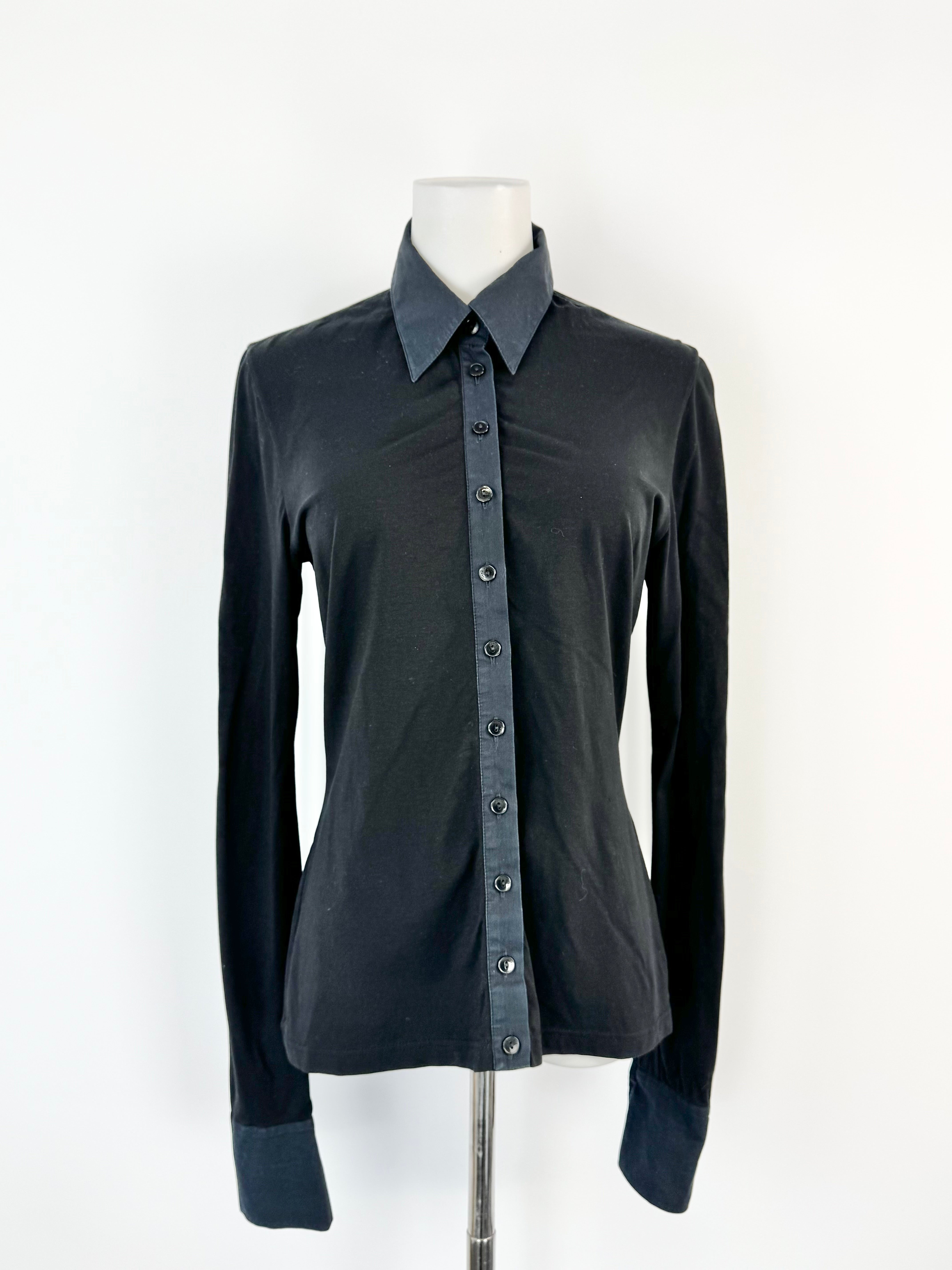 Black shirt on a mannequin against a white background