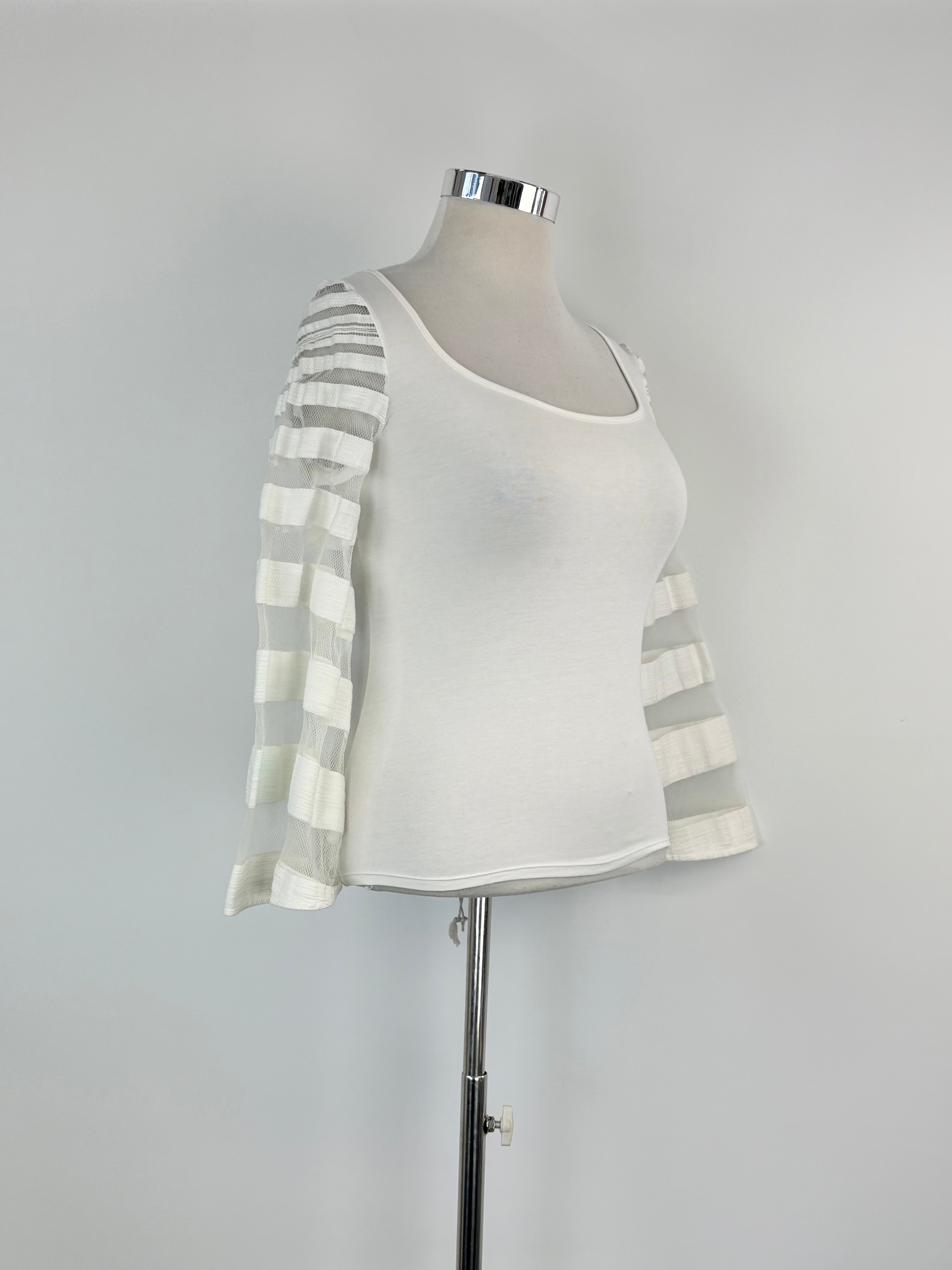 Mannequin wearing a white top with a striped gray and white cardigan on a gray background