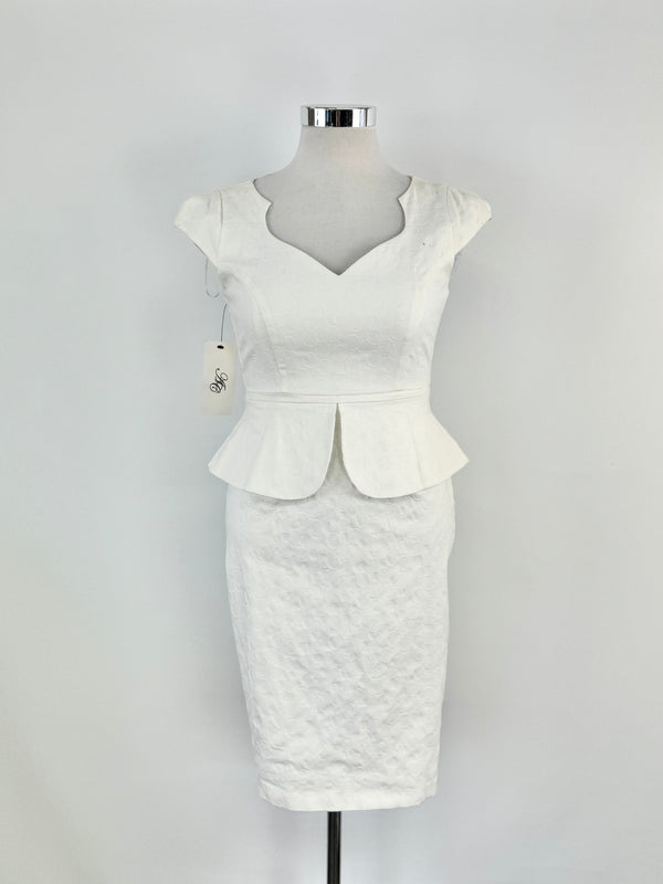 A white cream-colored dress with a sweetheart neckline, cap sleeves, and a peplum waist, displayed on a mannequin.