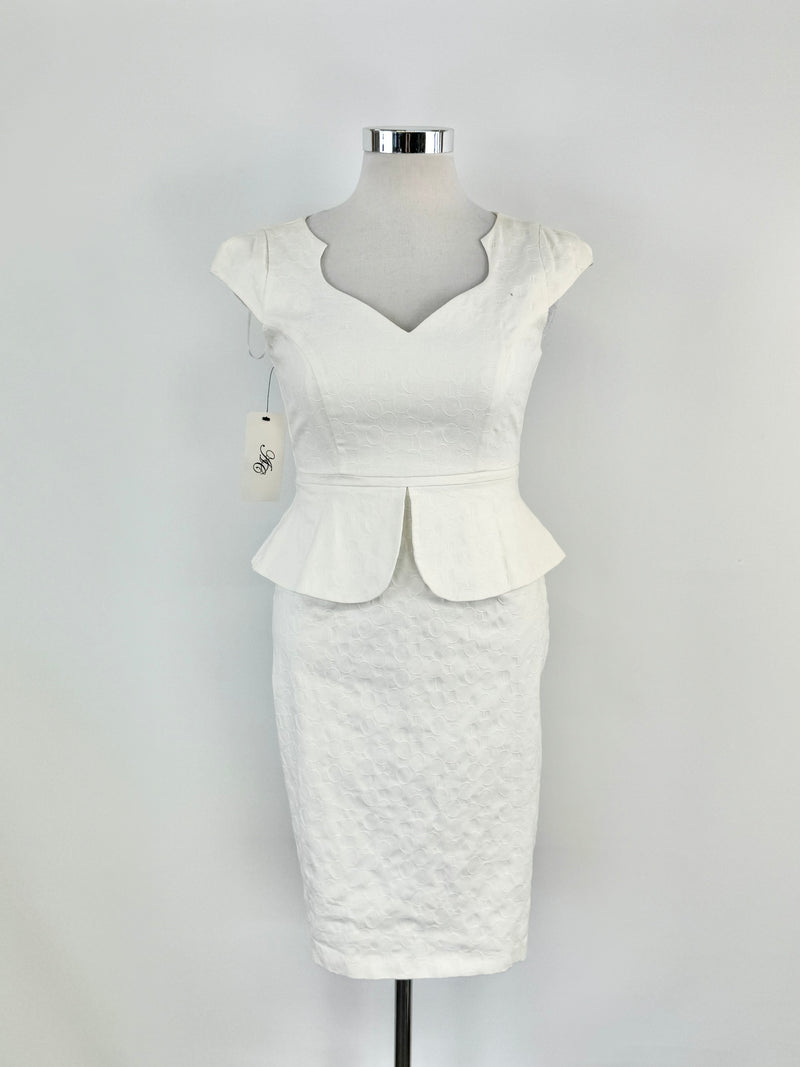 A white cream-colored dress with a sweetheart neckline, cap sleeves, and a peplum waist, displayed on a mannequin.