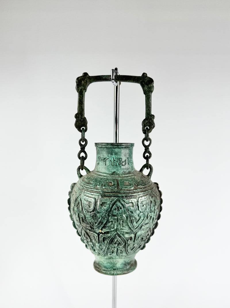 Bronze vase with intricate designs on a white background