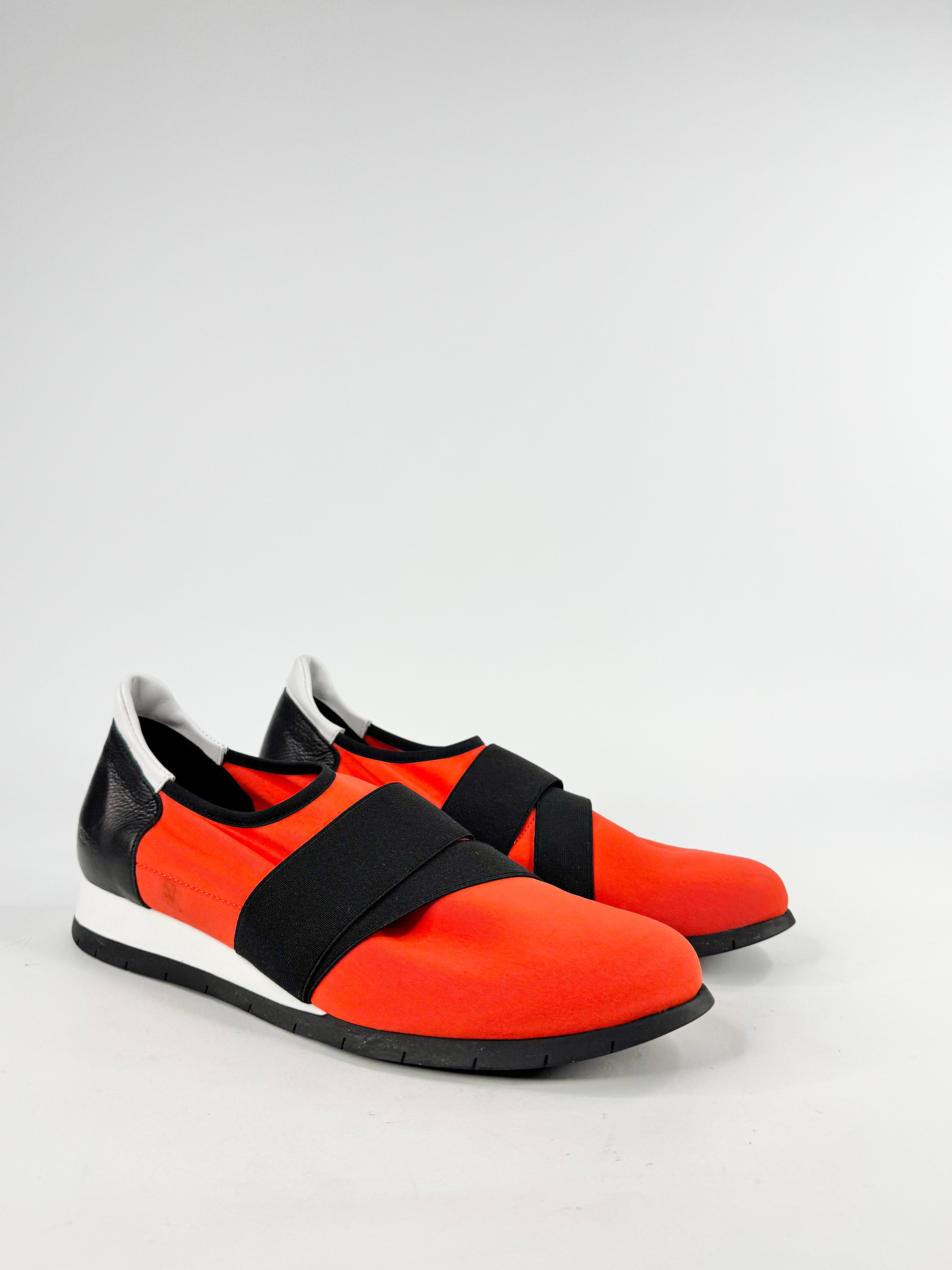 Orange and black shoes on a white background
