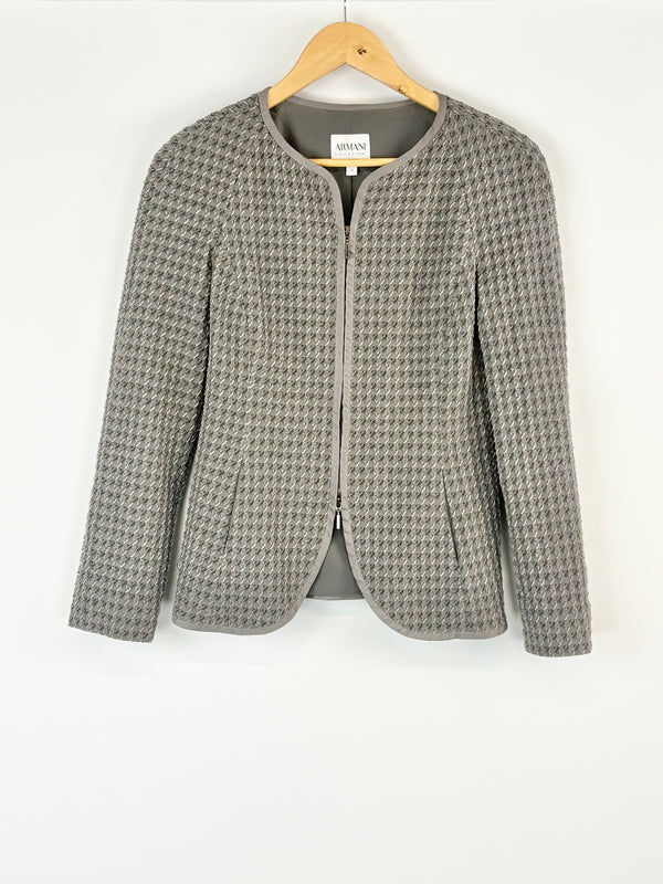 Houndstooth pattern jacket on a hanger against a white background