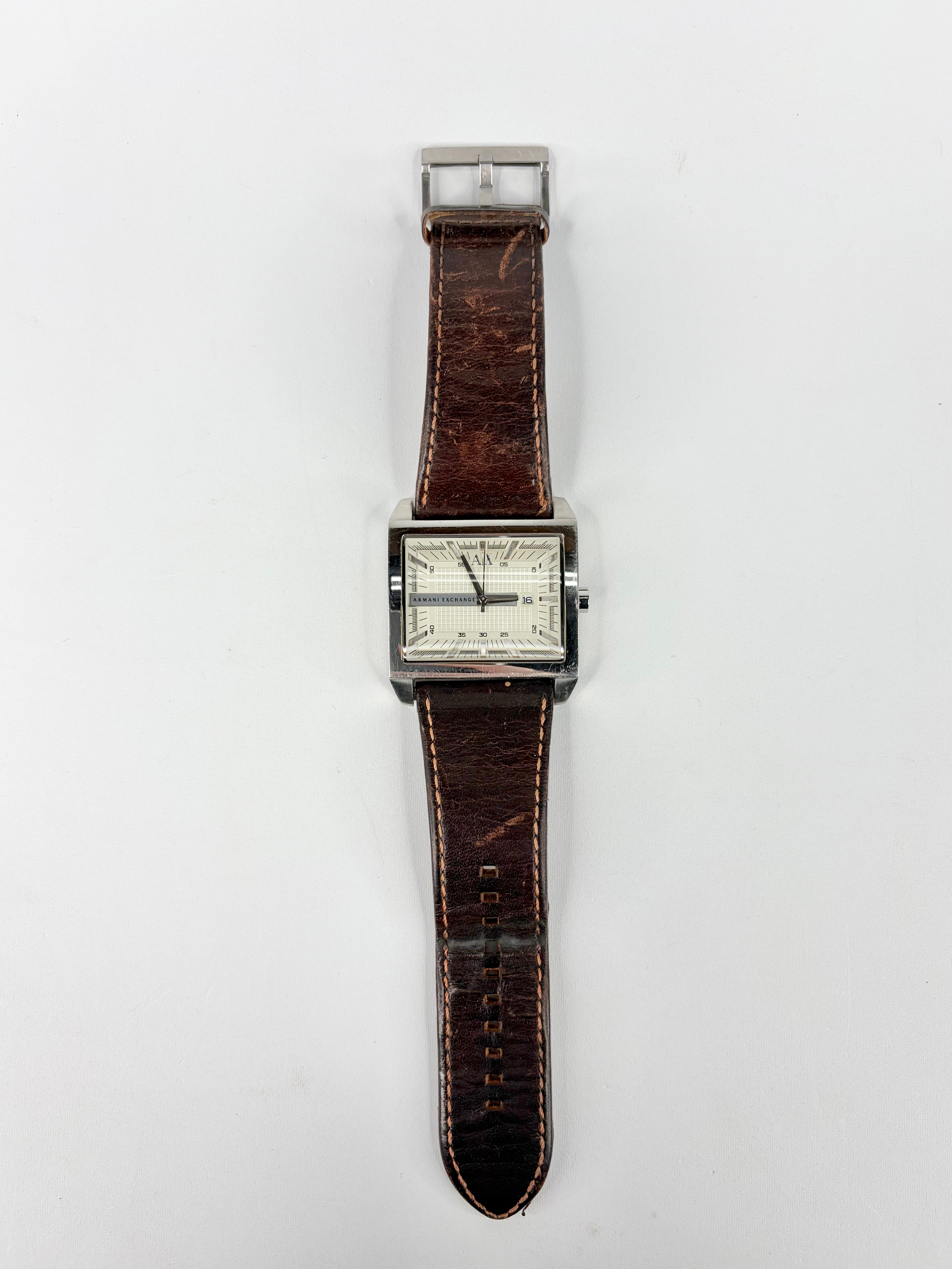 Vintage watch with brown leather strap on a white background