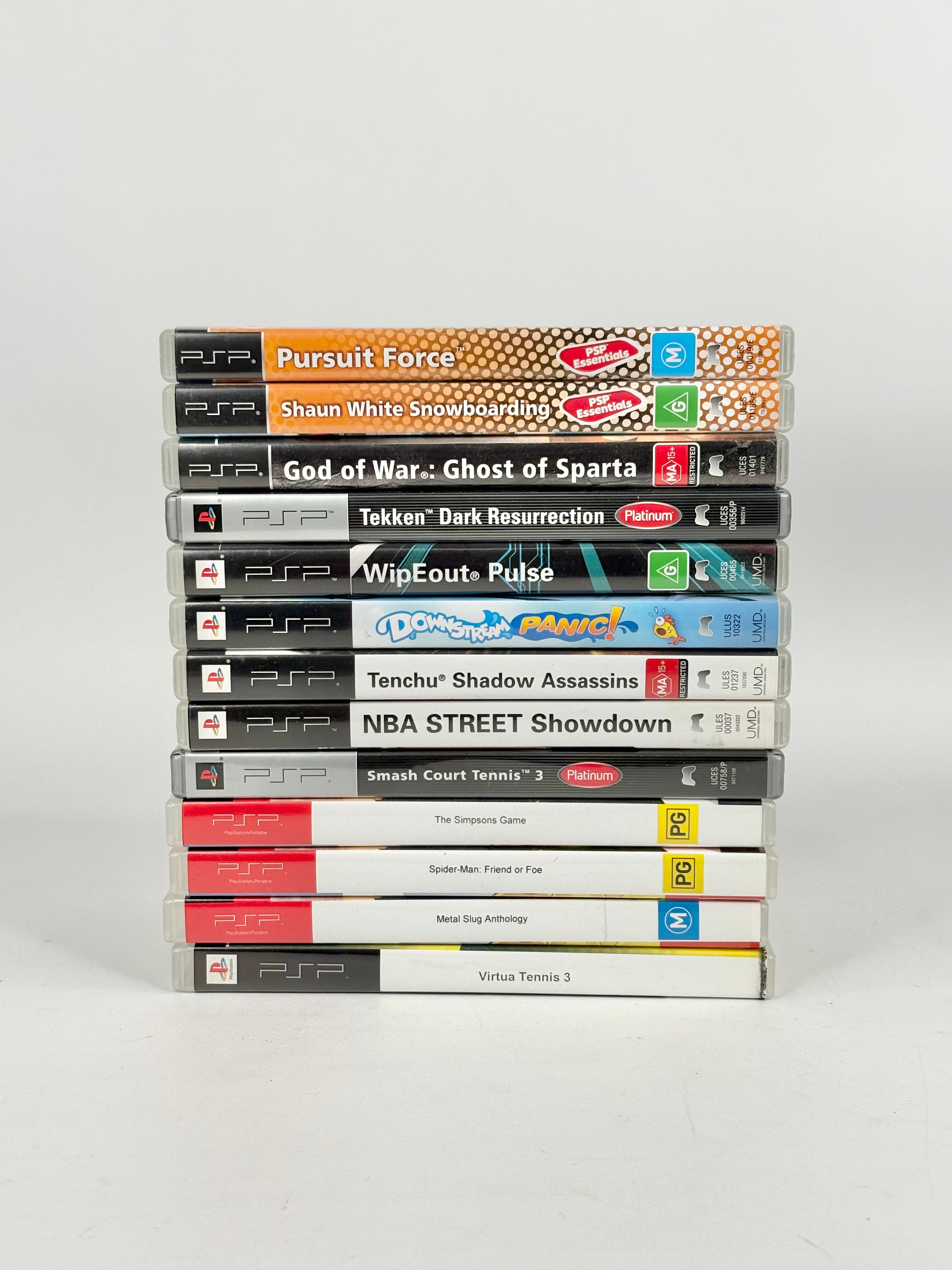 Stack of PSP games on a white background