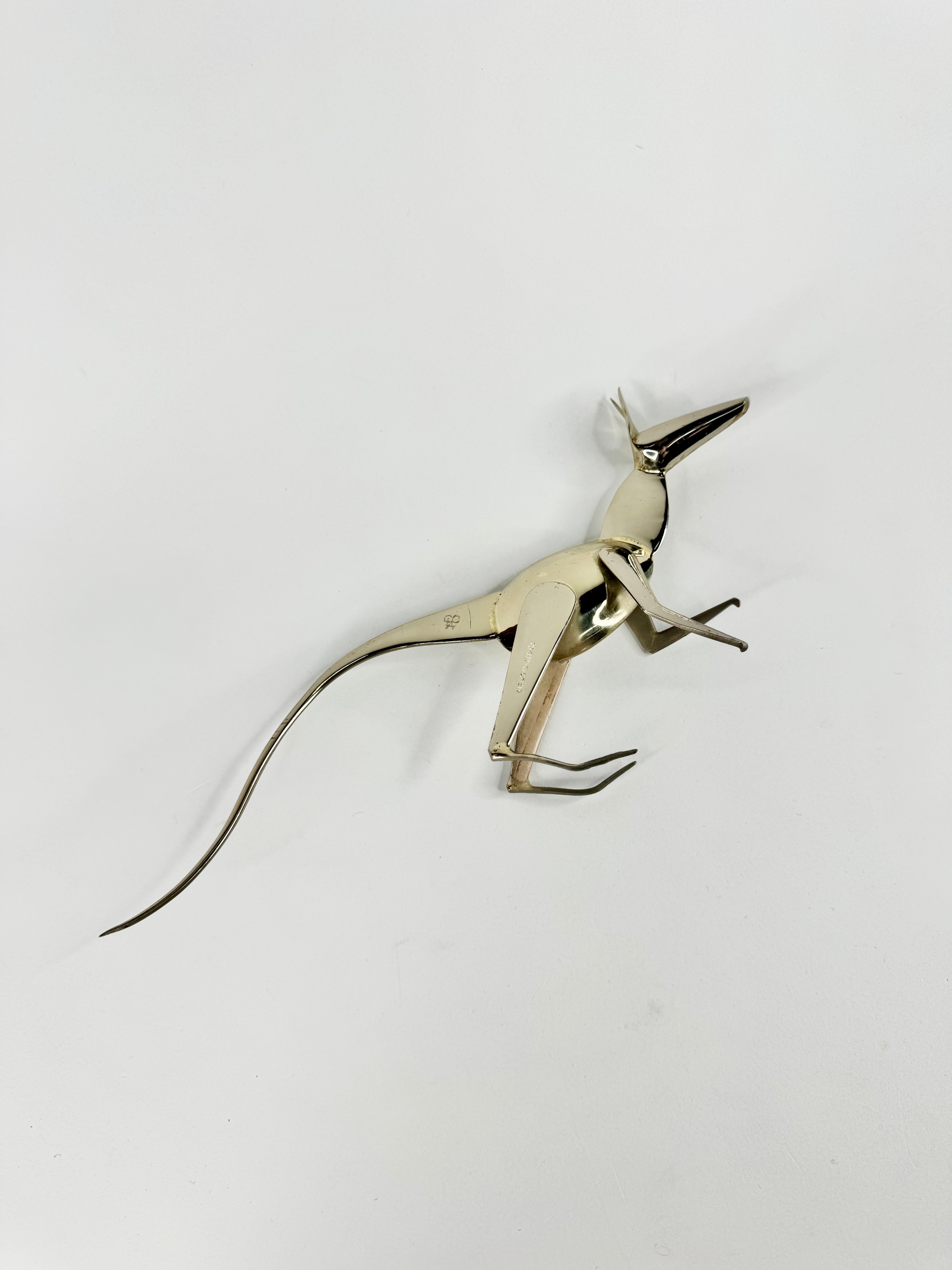 Metallic dinosaur figurine on a white background