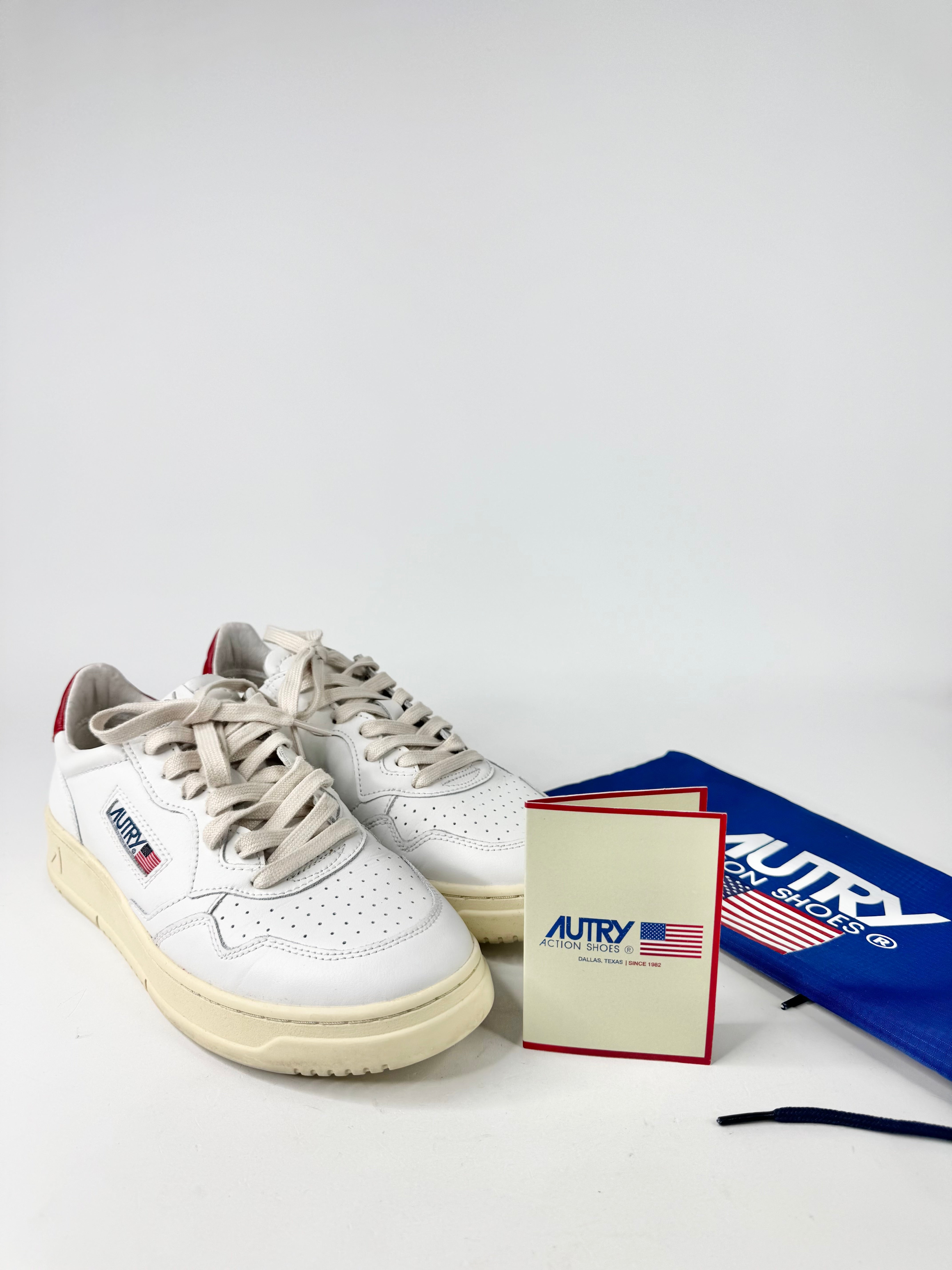 White sneakers with visible branding on a white background
