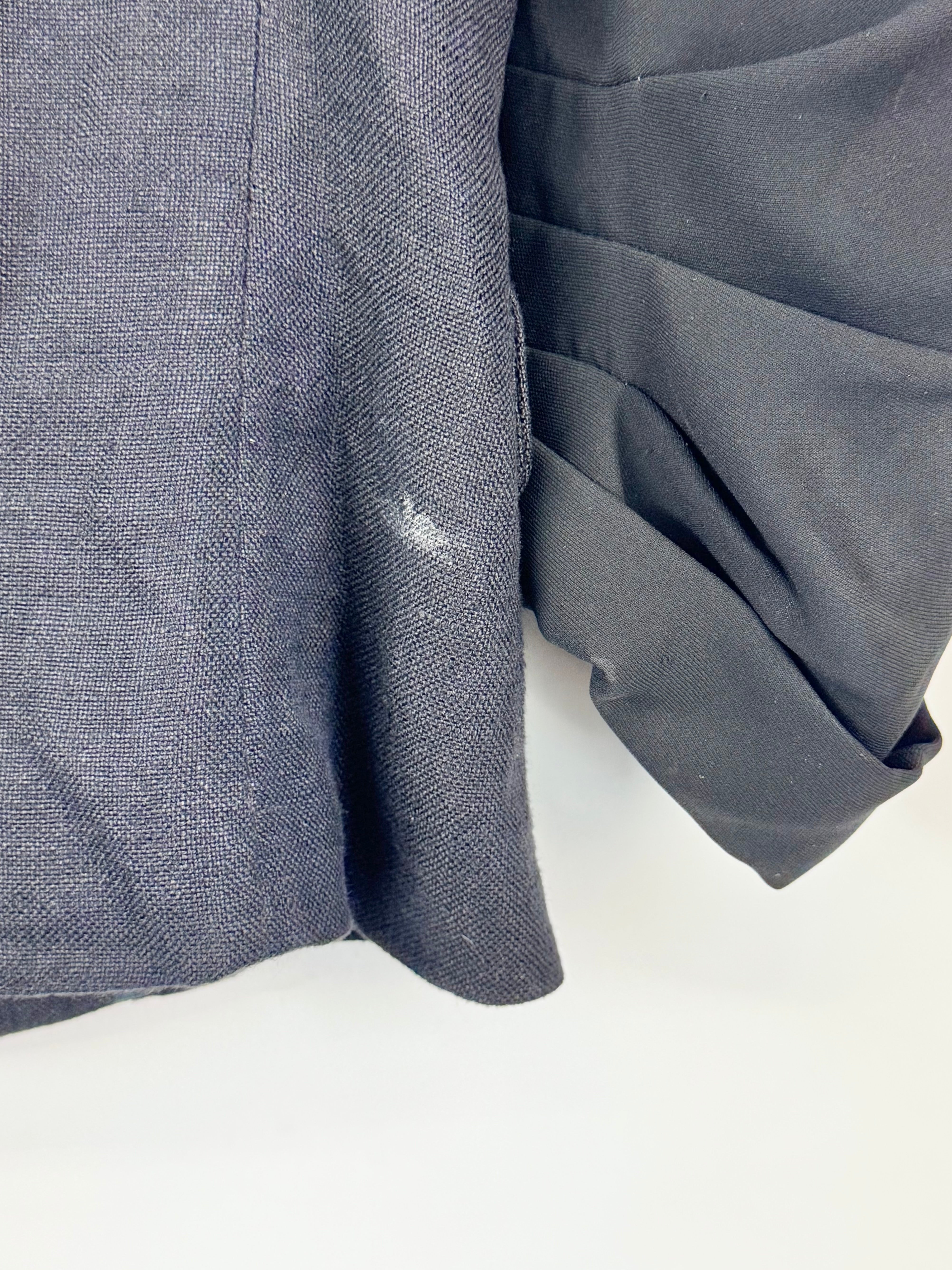 Close-up of a gray fabric with a visible stain on a white background