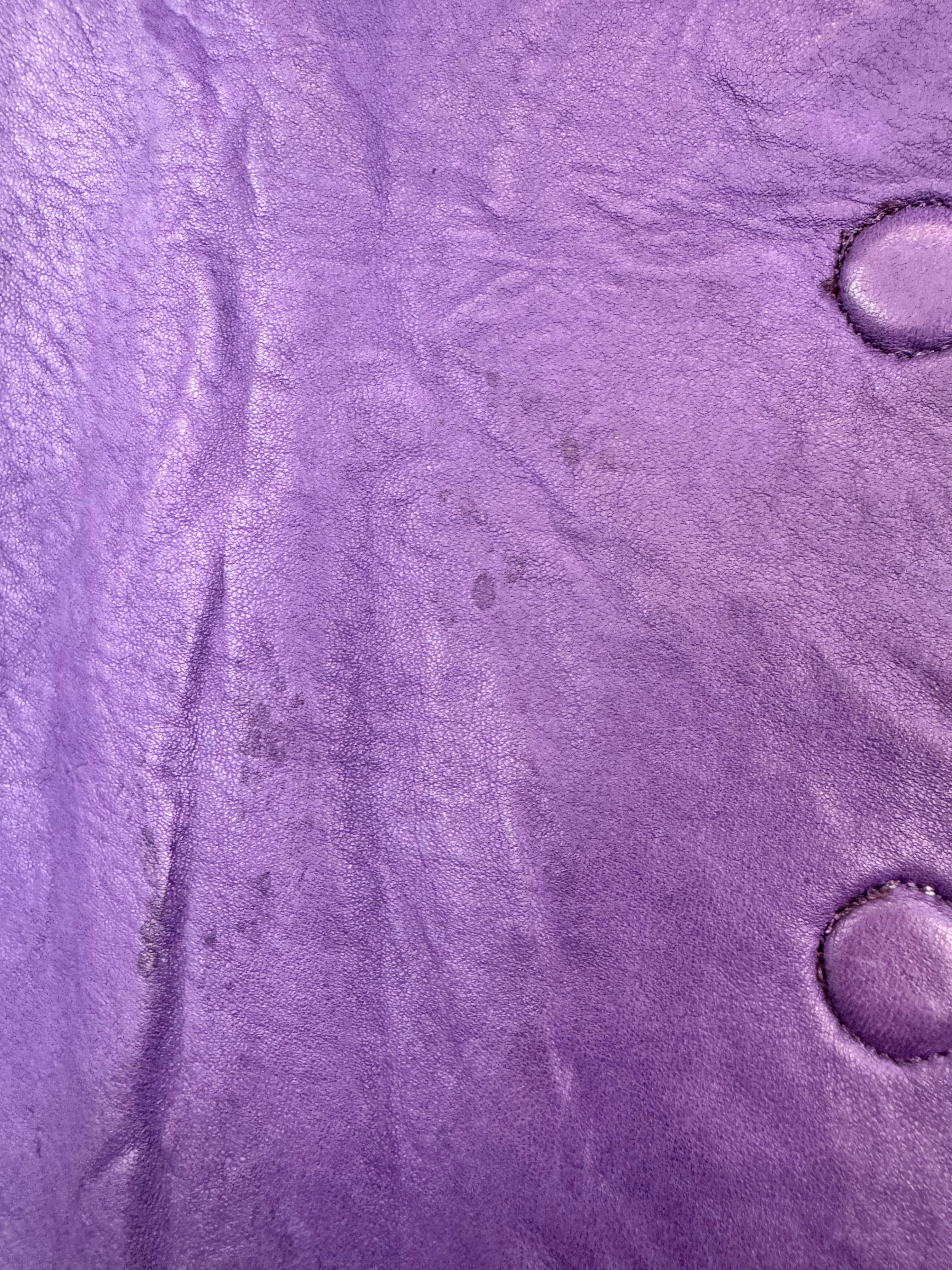 Close-up of purple textured material with circular patterns