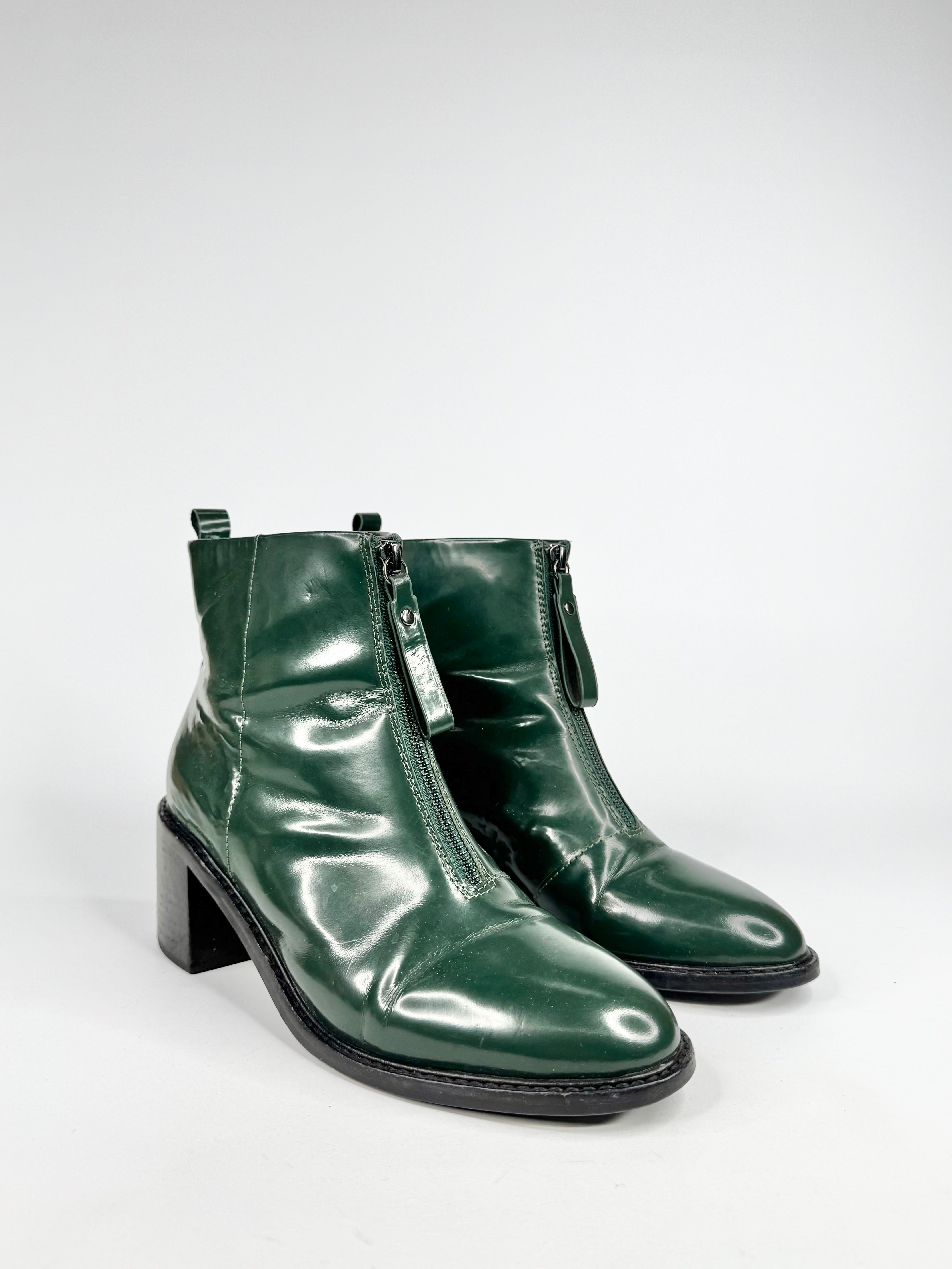 Green shiny ankle boots on a white background