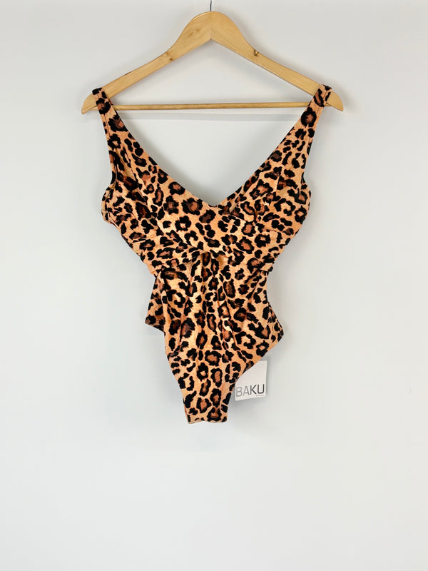 Leopard print swimsuit on a hanger against a white background
