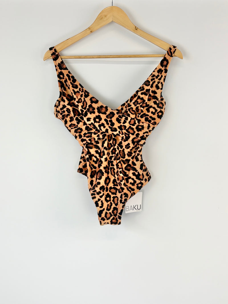 Leopard print swimsuit on a hanger against a white background