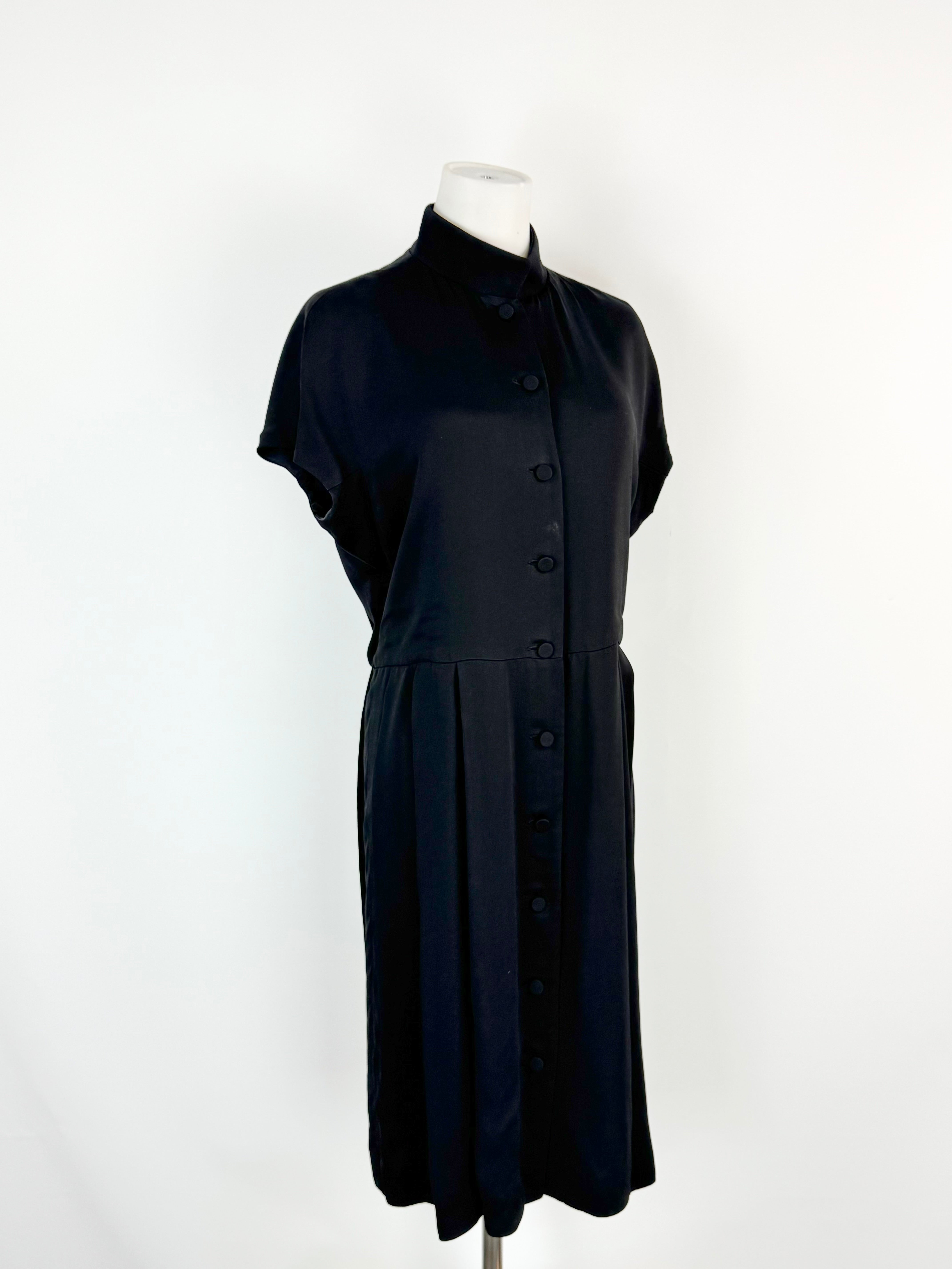 Black dress on a mannequin against a white background