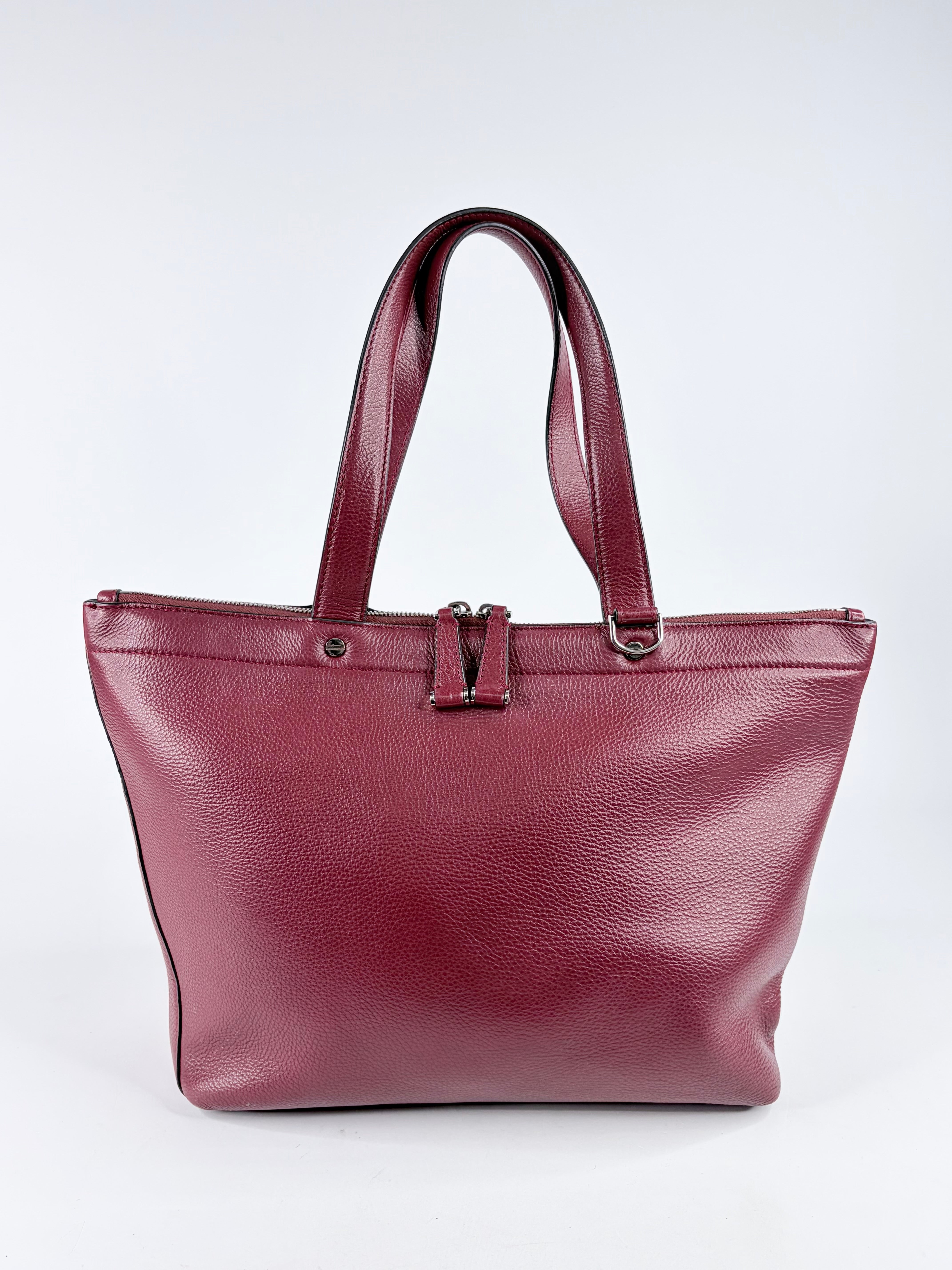 Maroon leather tote bag on a white background